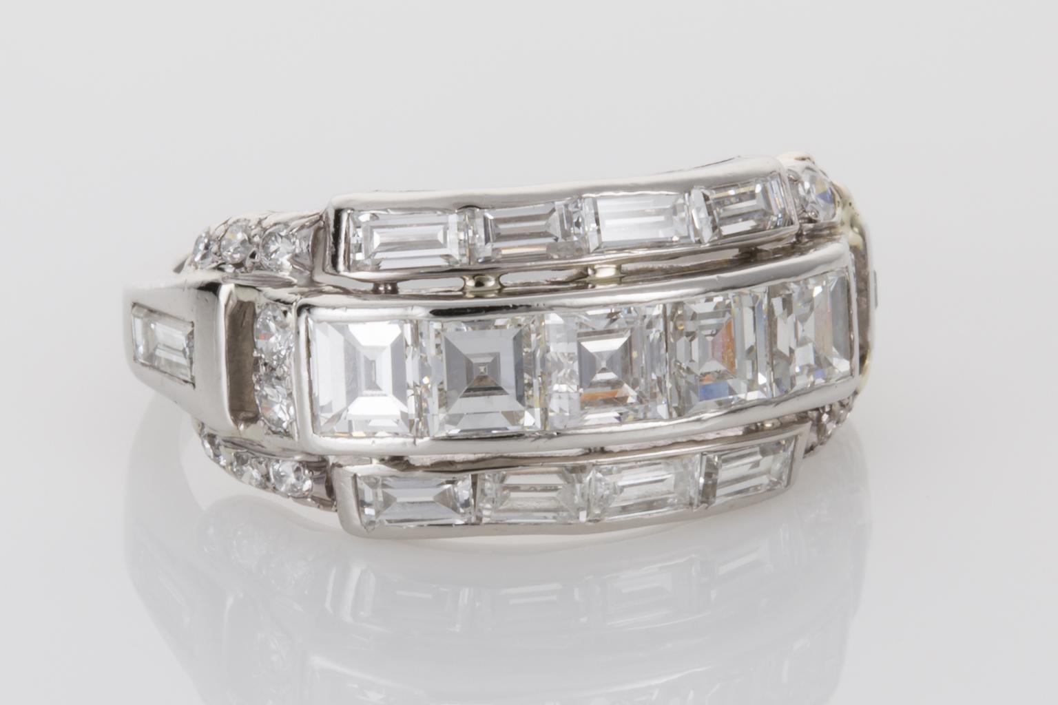 A beauty from another era, this stylish original platinum Art Deco ring is incredibly beautiful. Set with top quality diamonds the combination of the diamond cuts shows true Art Deco geometric drama. 
The channel set central diamonds consist of 5