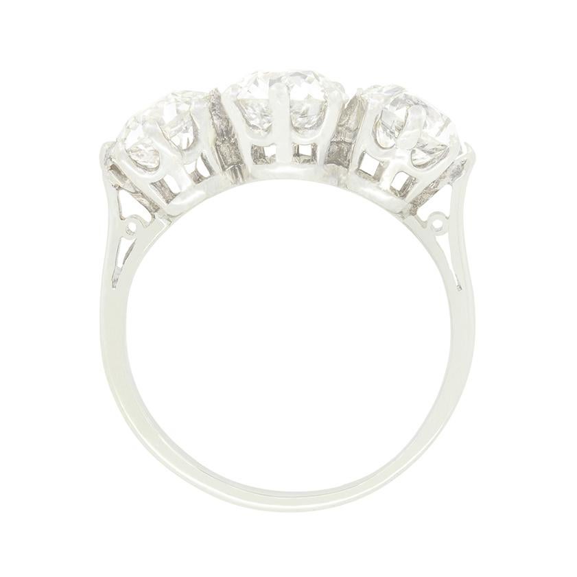 This stunning Art Deco three stone ring features a sparkling trio of old cut diamonds. At its centre sits the largest of the three at 1.25 carat, flanked by a pair of 0.1.00 carat diamonds on either side. The diamonds are of good quality with colour