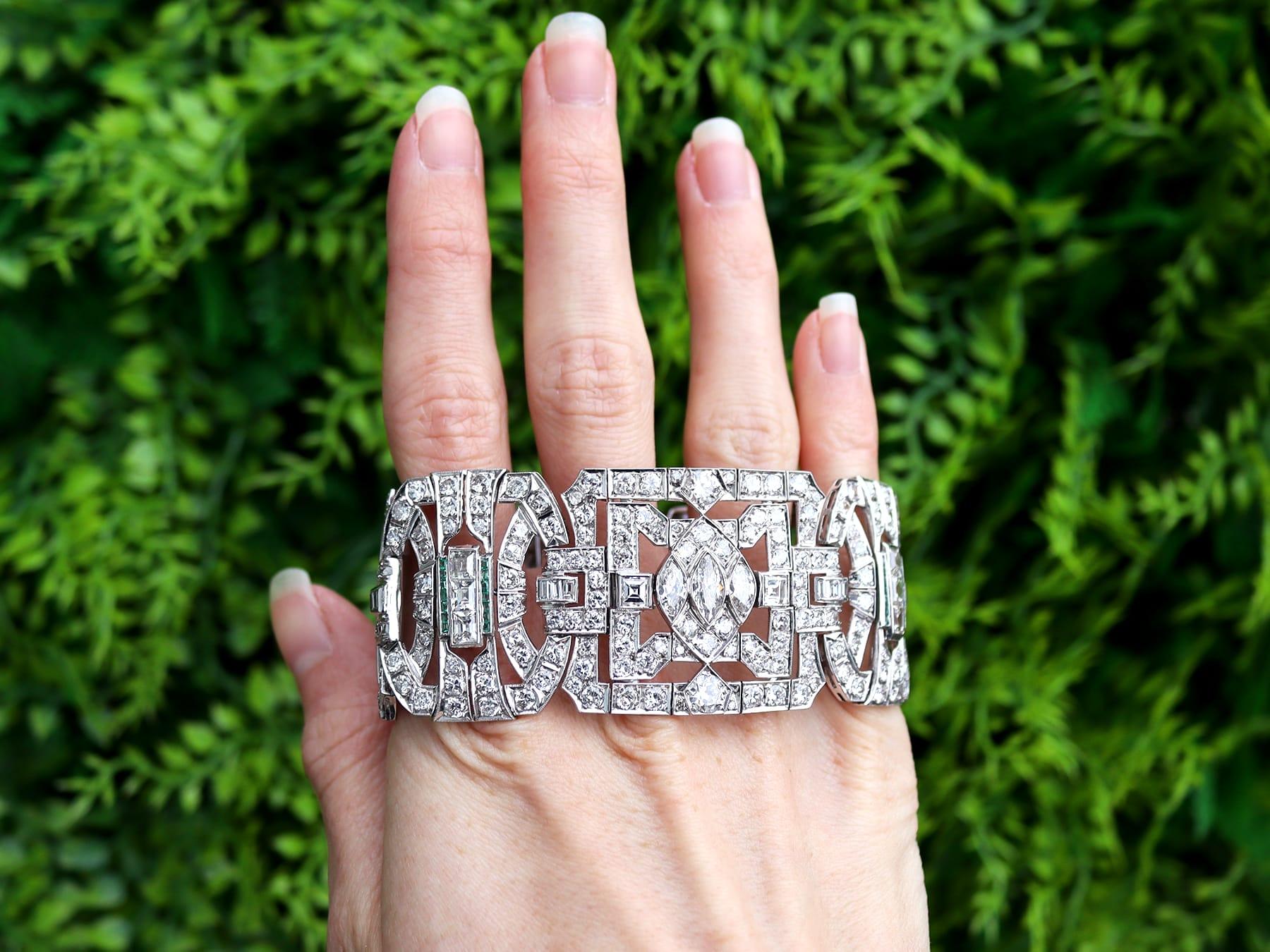 A magnificent, fine and impressive antique 1930's 33.25 carat diamond, 0.30 carat emerald and platinum Art Deco bracelet; part of our diverse antique diamond bracelets collection.

This magnificent, fine and impressive antique Art Deco bracelet has