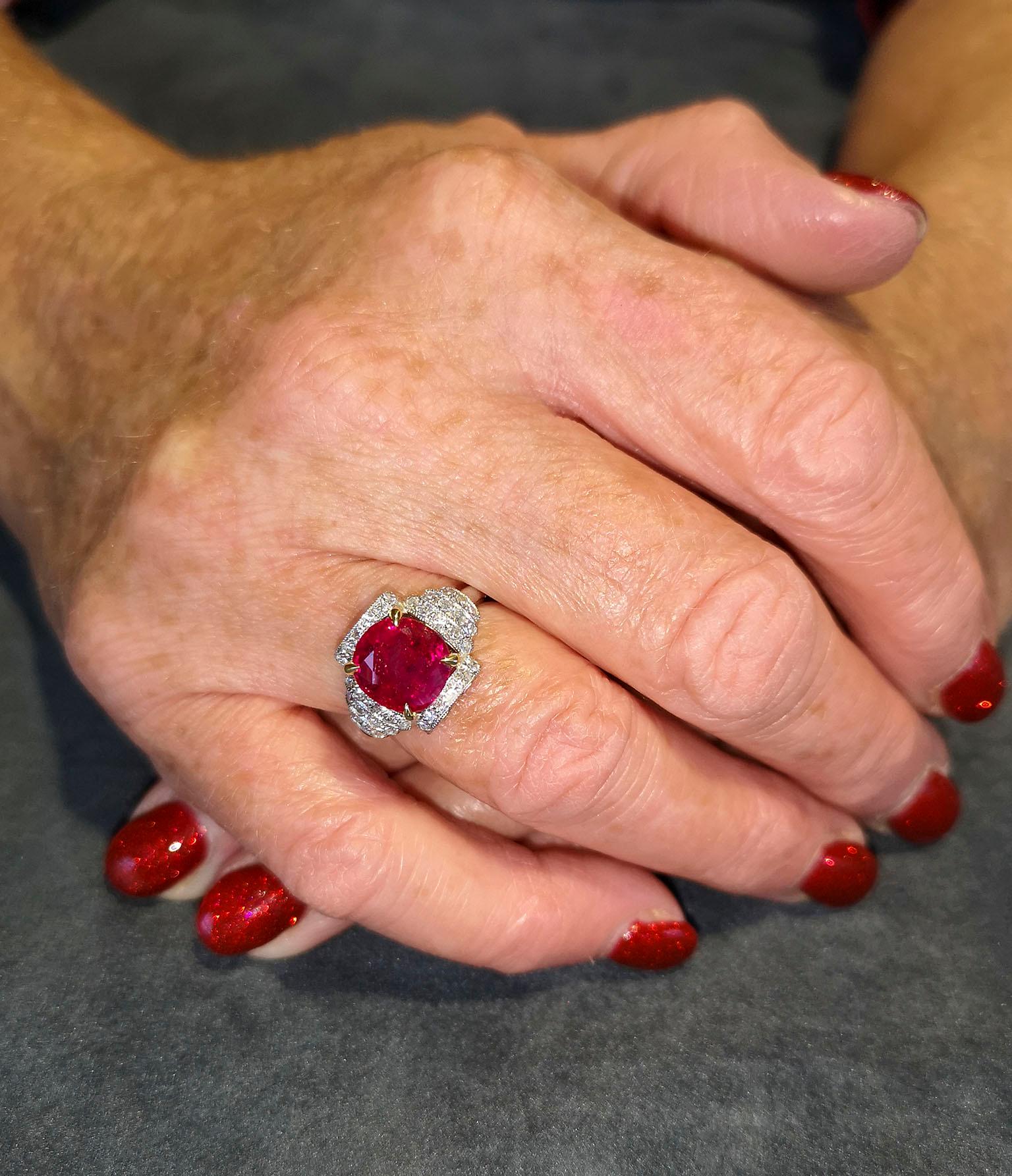  An exquisite, finest gem quality ruby and diamond Art Deco cocktail ring. Featuring a cushion-cut central ruby of the most magnificent blood-red colour, mounted in four claws, flanked on each side by tiered steps of pavé diamonds, leading to a