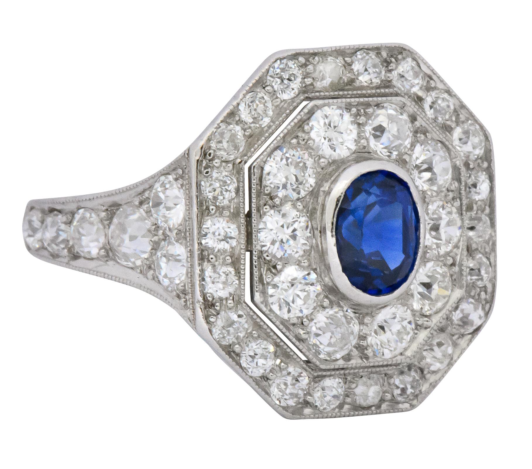 Centering an oval cut no heat sapphire weighing approximately 1.00 carat and is bright royal blue in color

Bezel set within an octagonal mounting featuring a double halo of diamonds

Total diamond weight approximately 2.50 carats; G to J color with