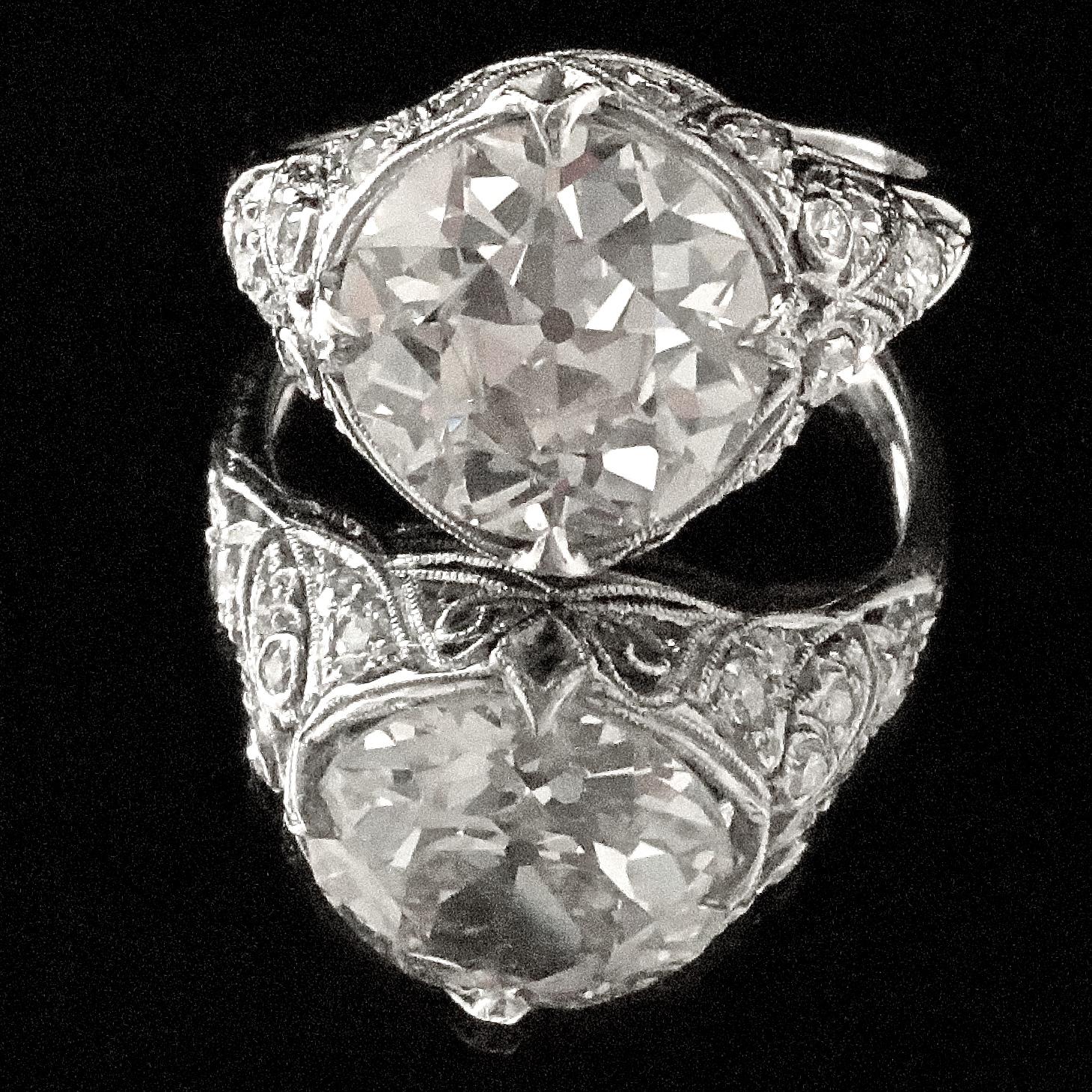 This ring is truly an Art Deco masterpiece, featuring symmetry, fine detail, and a display of elegance synonymous with the era. What was a trend in 1920's now is a reminder of that wonderful time. The ring features an old European cut diamond