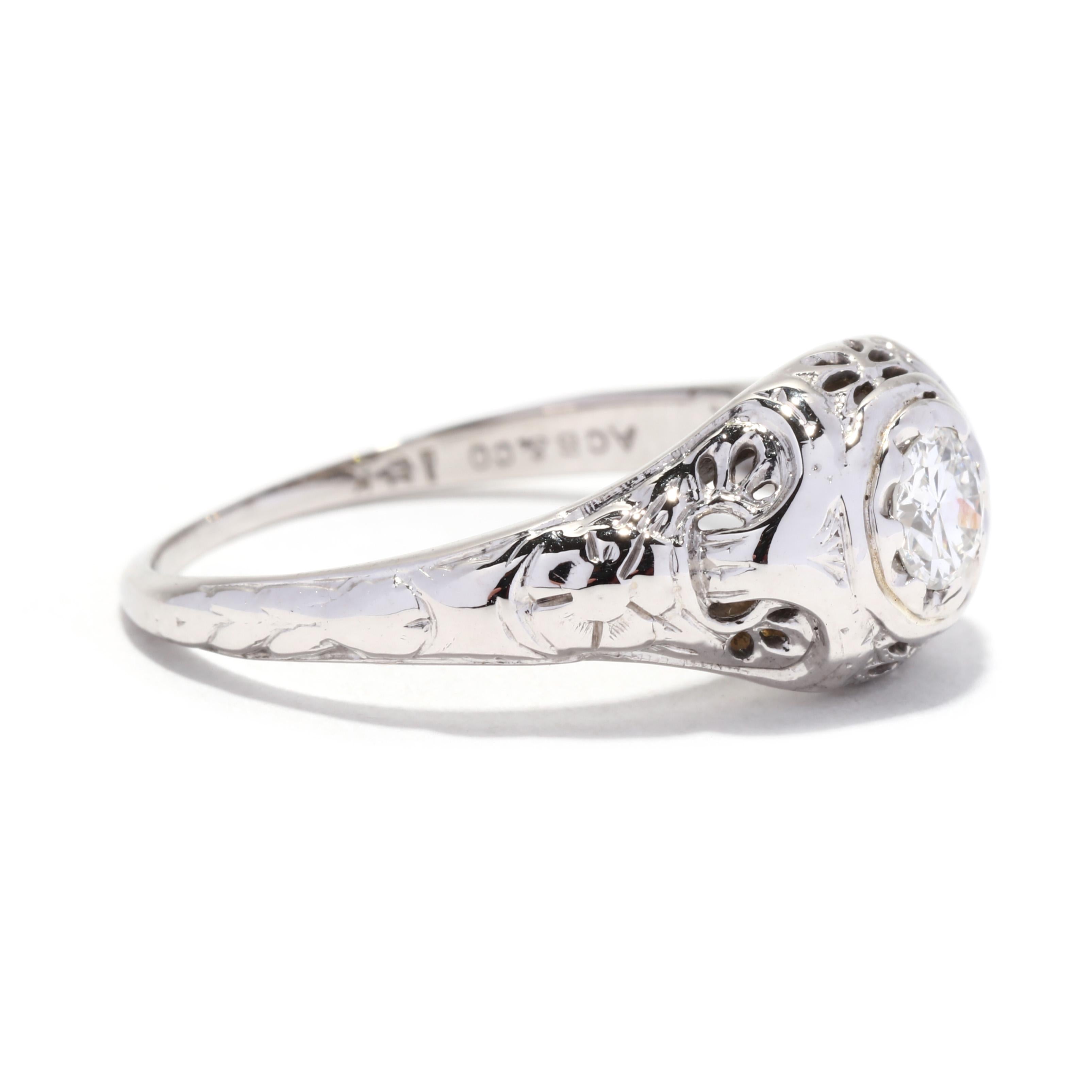 An Art Deco 18 karat white gold old European cut diamond engagement ring. This classic engagement ring features an old European cut diamond weighing approximately .36 carat set in a tapered floral filigree and engraved mounting.

Stones:
- diamond,
