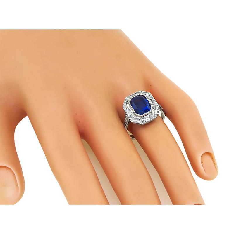 This is a stunning platinum engagement ring from the Art Deco era. The ring is centered with a lovely AGL certified cushion cut natural no heat Ceylon sapphire that weighs 3.76ct. The center stone is accentuated by sparkling French and round cut
