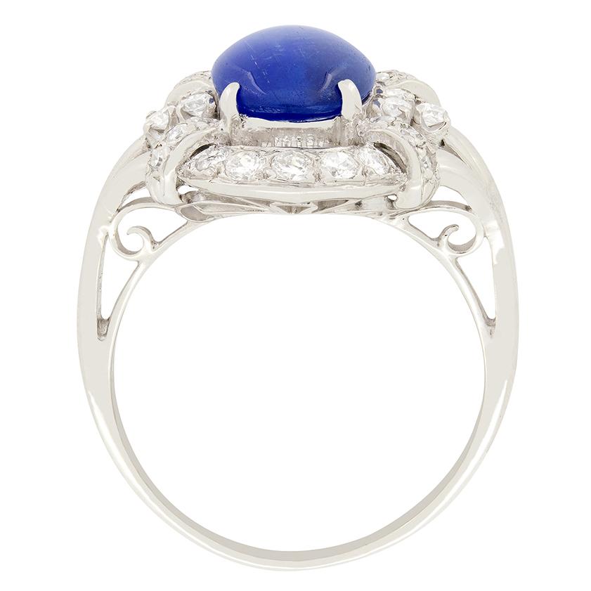 This art deco show stopper features a stunning Star Sapphire at its centre. The 3.80 carat sapphire is Cabochon cut and mounted in platinum. Decorative metal work features at the top and bottom of the central stone which connects it to the two semi