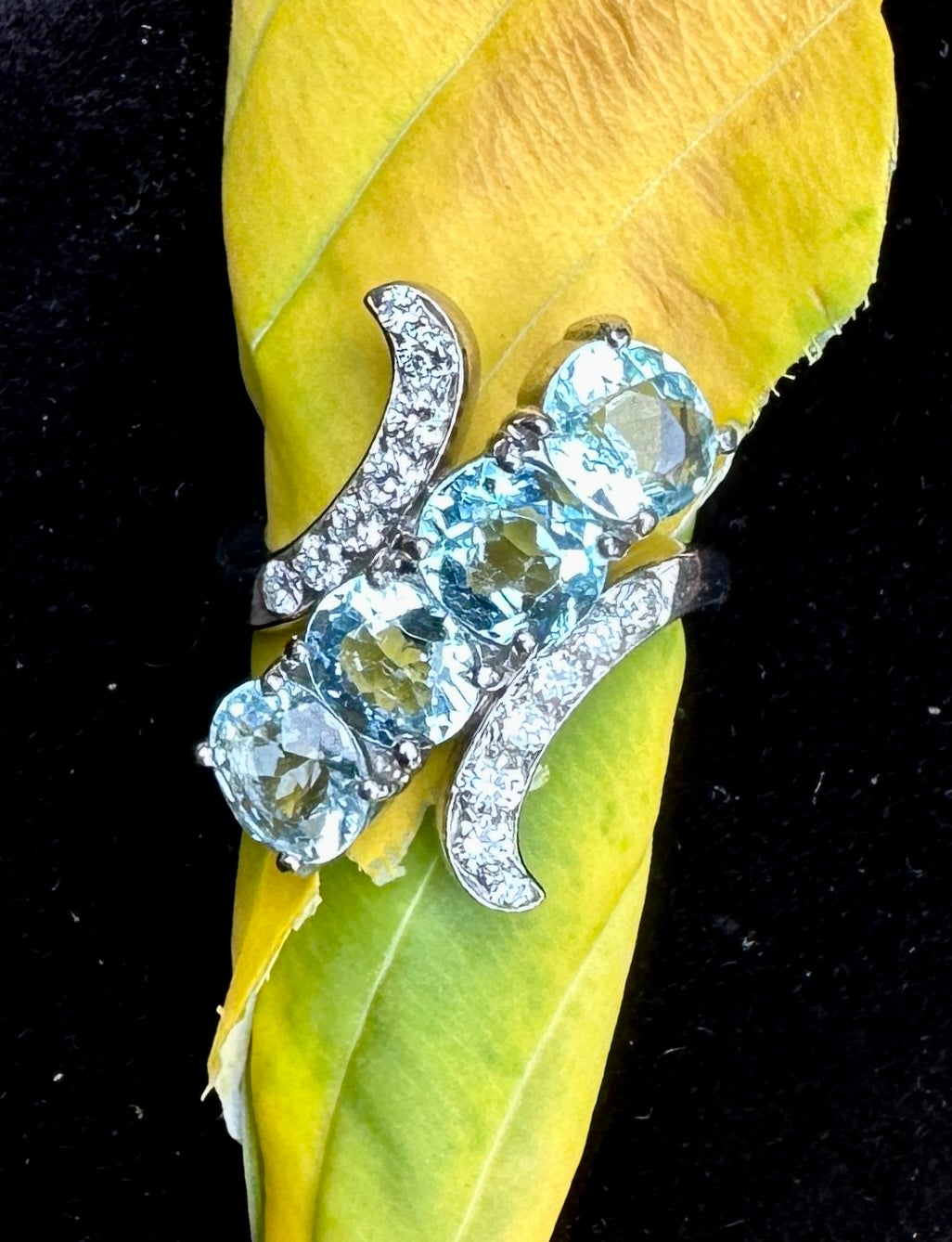 This is a magnificent Art Deco Aquamarine and Diamond Ring in a Palladium setting of great beauty.  The Art Deco masterpiece of a ring is centered by four gorgeous Oval Faceted Natural Aquamarine gems with exquisite Aqua color.  The Aquamarines are