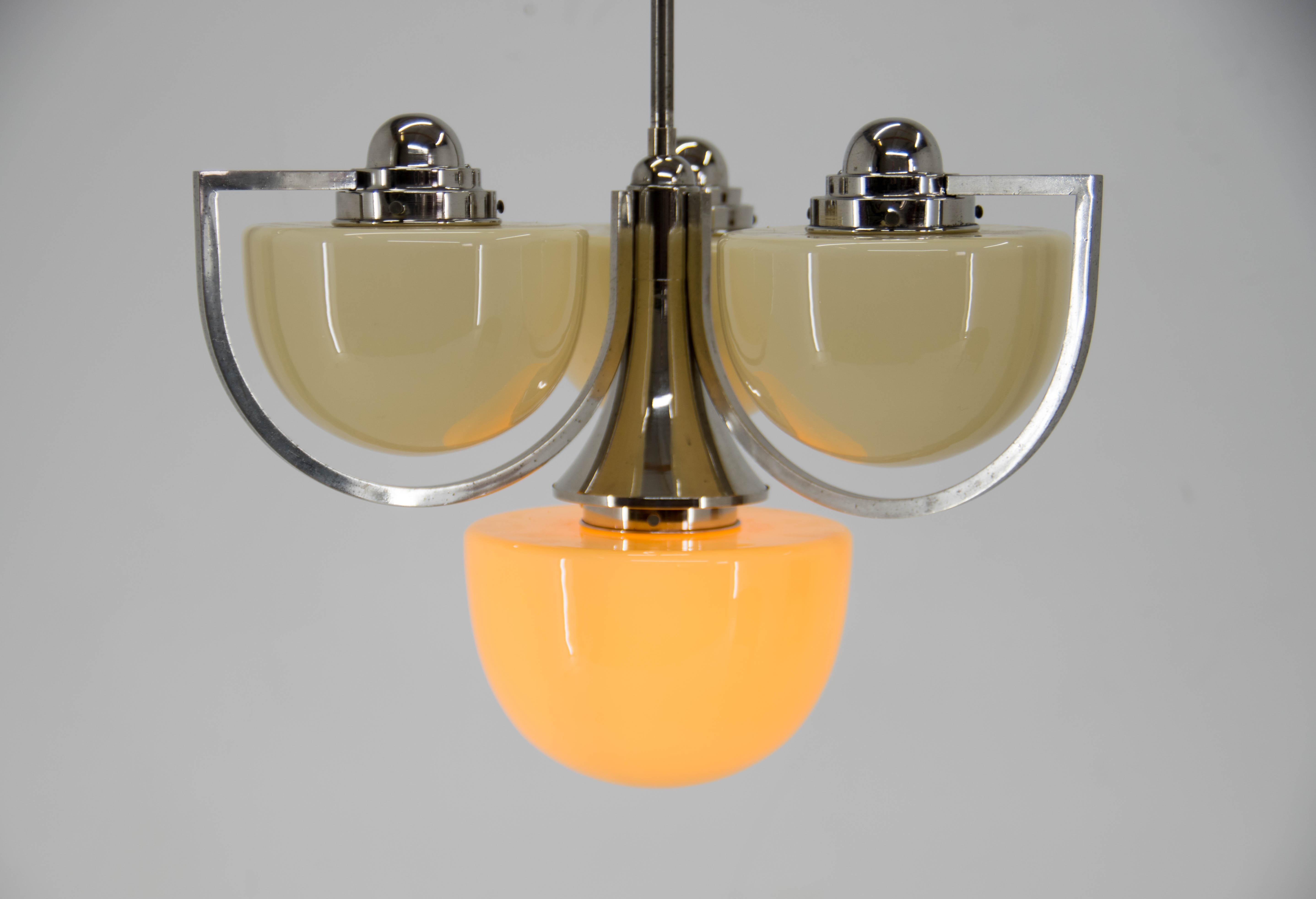 Beautiful unique Art Deco chandelier. Unusual shape of glass shades requires special way of flexible sockets - visible on photo with rotating socket.
Central rod could be shortened on request.
Completely restored: nickel with minor age patina
