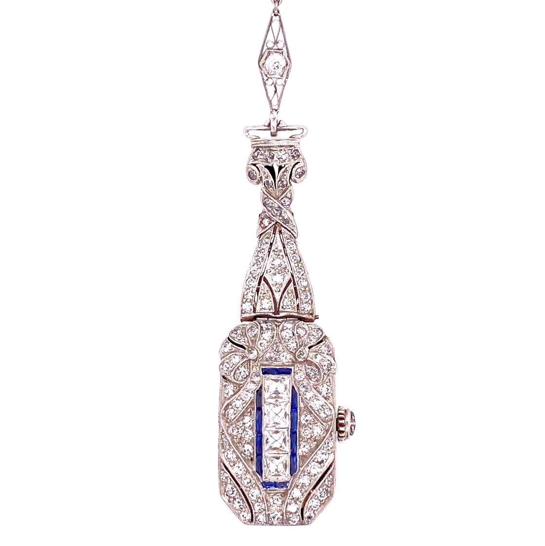 Beautiful and Finely detailed Platinum Diamond and Blue Sapphire accents Watch Pendant Necklace and Diamond set matching chain. Hand crafted in Platinum. Chain measures approx. 24 inches. This pendant epitomizes vintage charm and would make a lovely