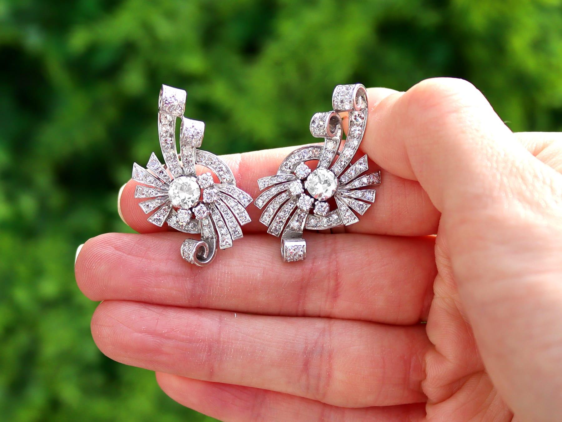 A stunning, fine and impressive pair of vintage 4.39 carat diamond and platinum drop earrings in the Art Deco style; part of our diamond jewelry collections.

These exceptional vintage Art Deco earrings have been crafted in platinum.

Each opposing