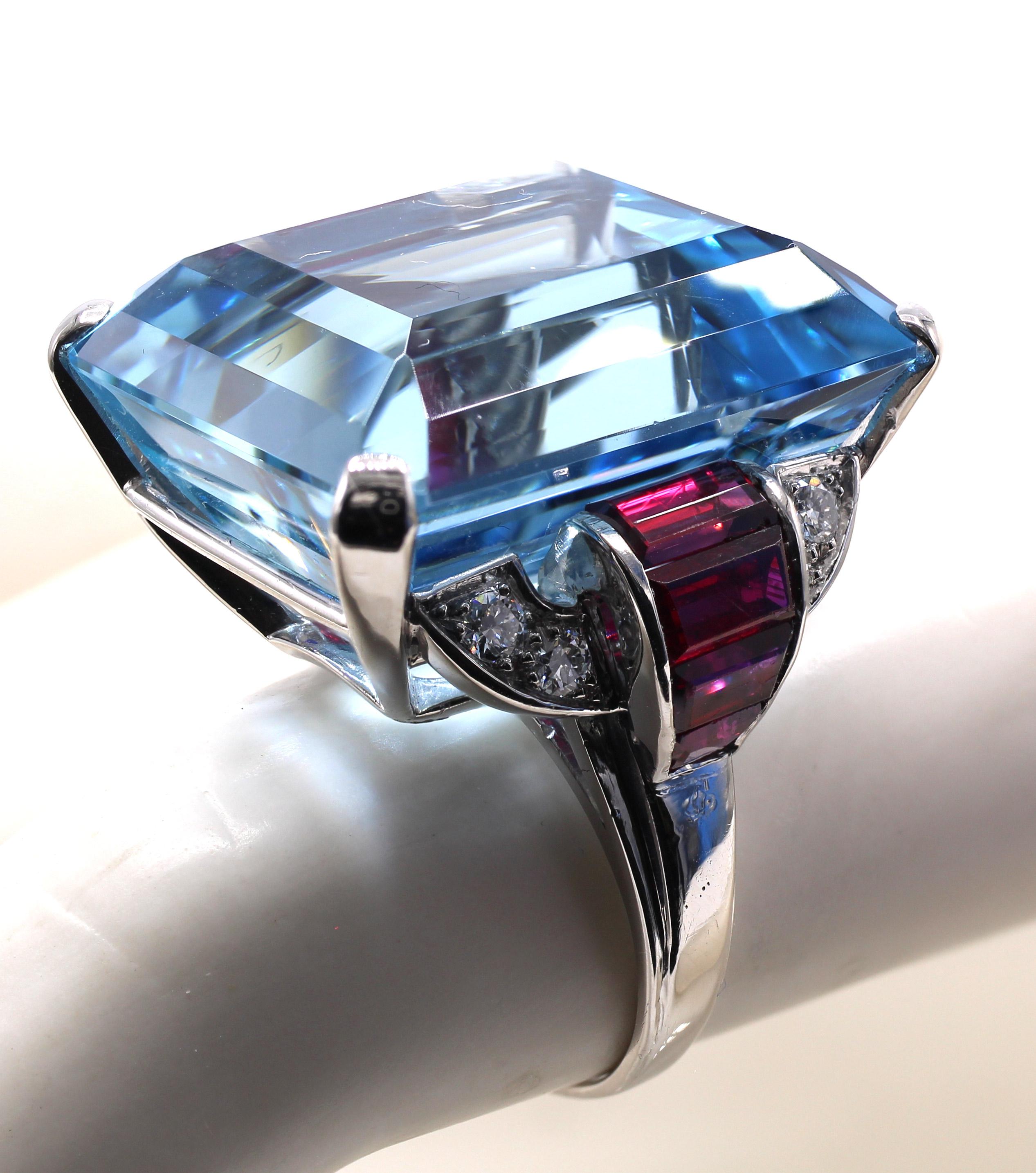 The center piece of this gorgeous Art Deco ring from ca 1935 is a Santa Maria color perfectly cut aquamarine weighing 44.28 carats. The rectangular step cut aquamarine has an amazing color saturation and is crystal clear with wonderful brilliance