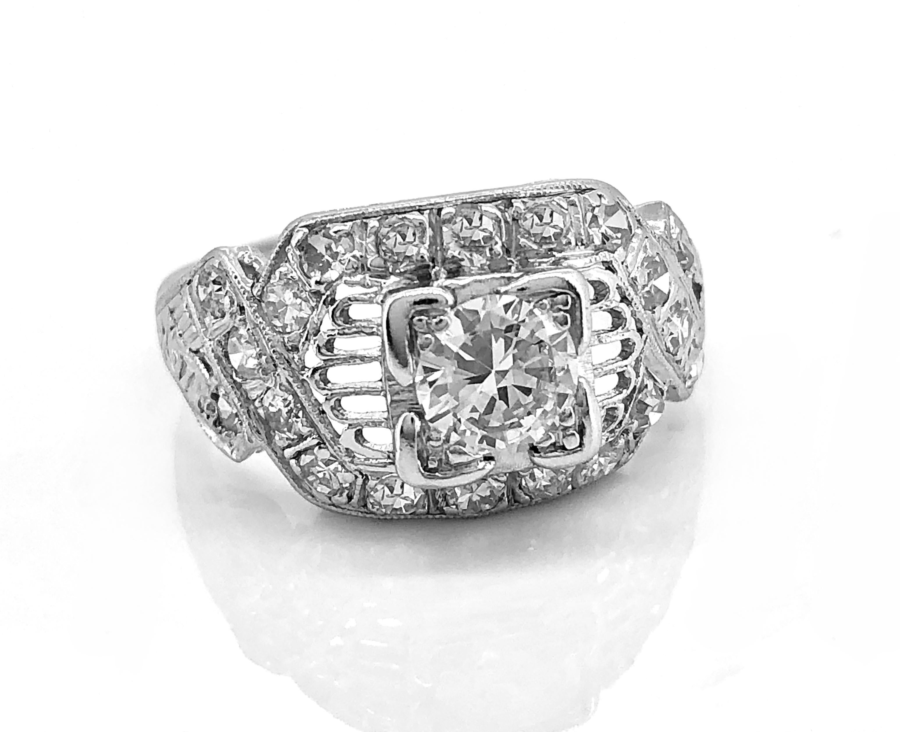 A romantic and radiant Art Deco diamond Antique engagement ring featuring a .45ct. apx. center diamond of VS1 clarity and K color. The accenting diamond melee weighs .50ct. apx. T.W. The center diamond is accented with open filigree to the east and