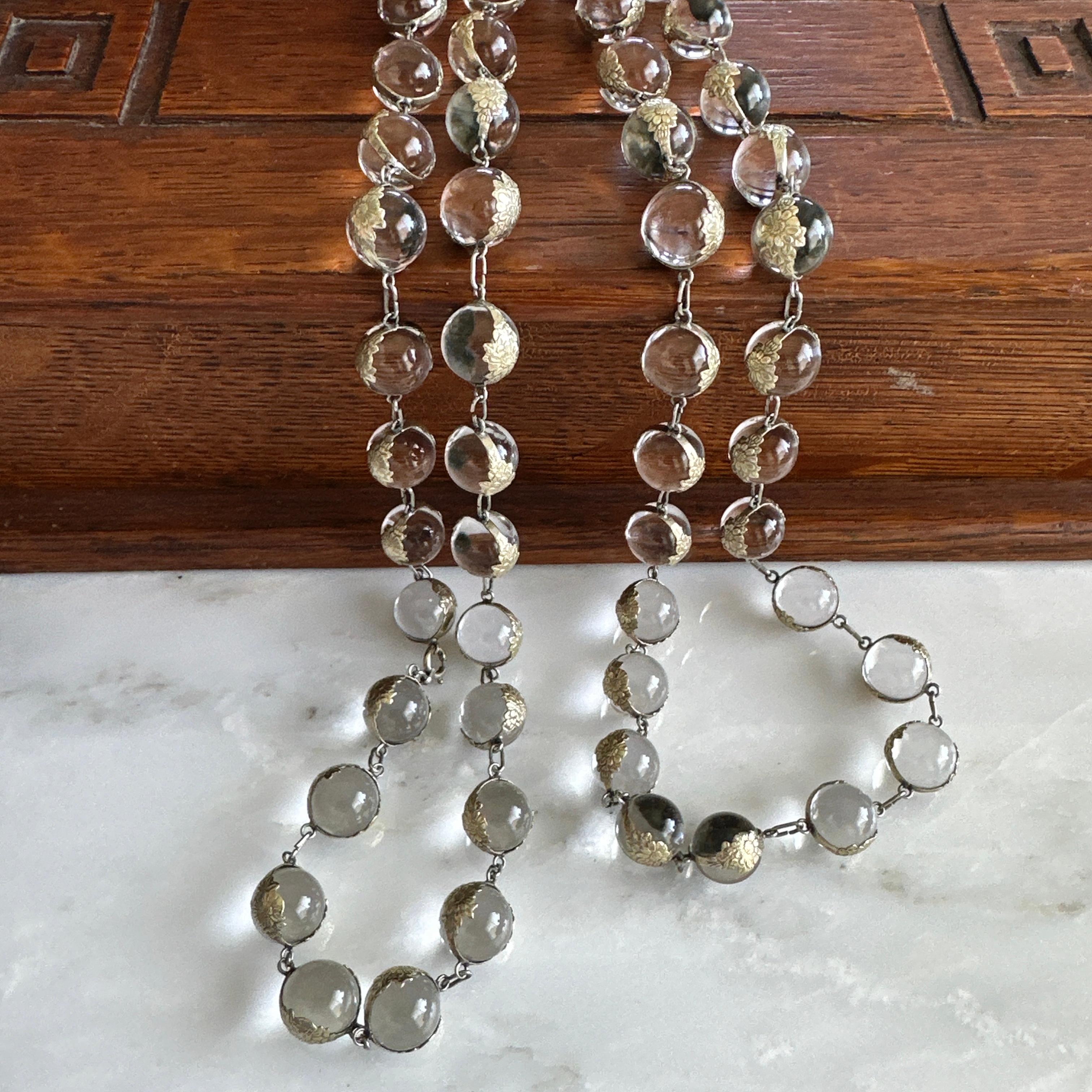 Details:
Fabulous Art Deco Pools of Light necklace in sterling silver. Necklace is in wonderful condition, and is 45 inches in length, with a clasp which makes it easy to wrap this two times around your neck! The 53 clear orbs making up the balls