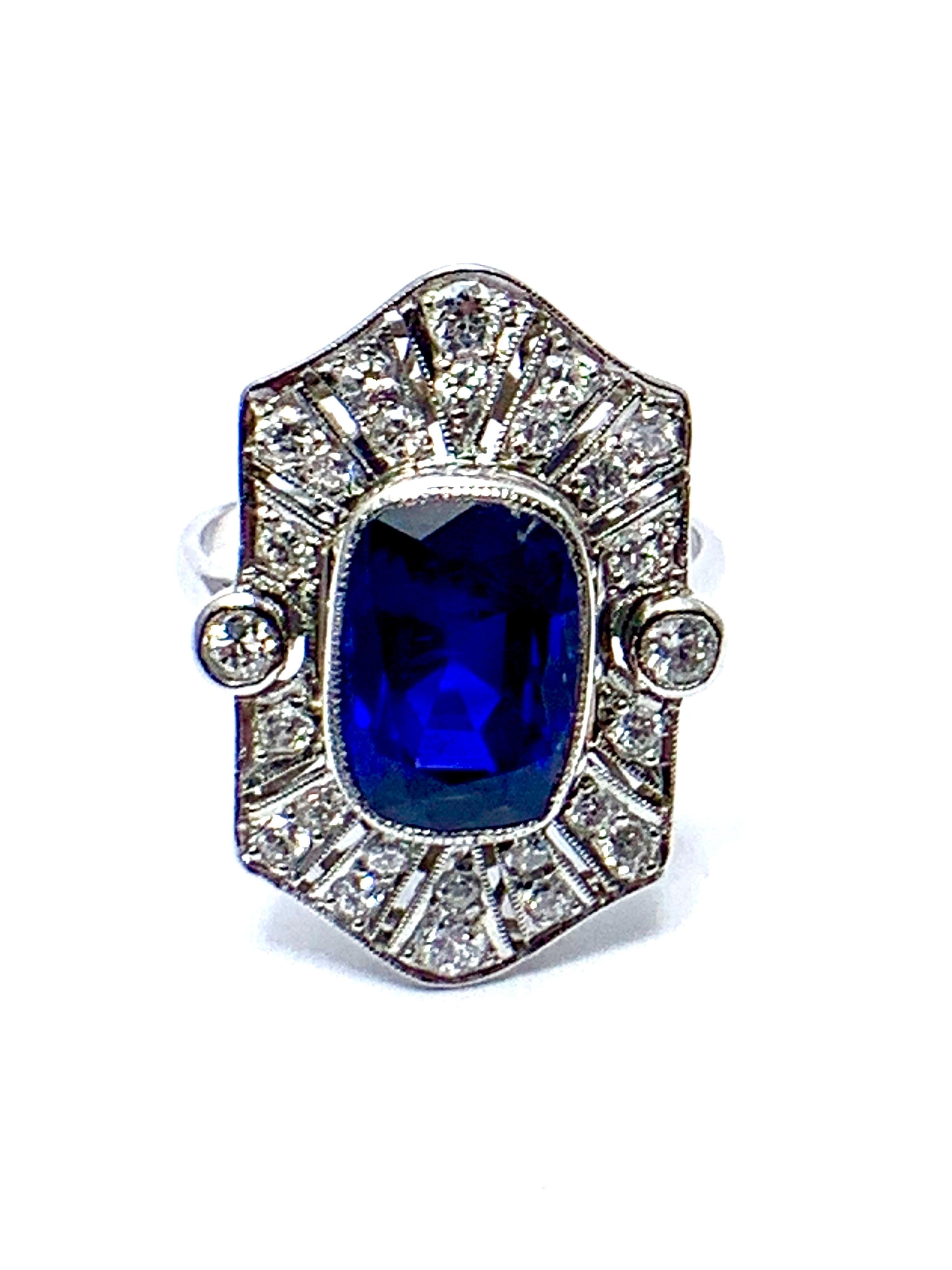 A stunning Art Deco Style Sapphire and Diamond platinum ring!  The 4.76 carat cushion shaped Sapphire is bezel set with a milgrain edge sitting atop a balanced dispersion of old European and single cut Diamonds that total 0.69 carats.  The sapphire