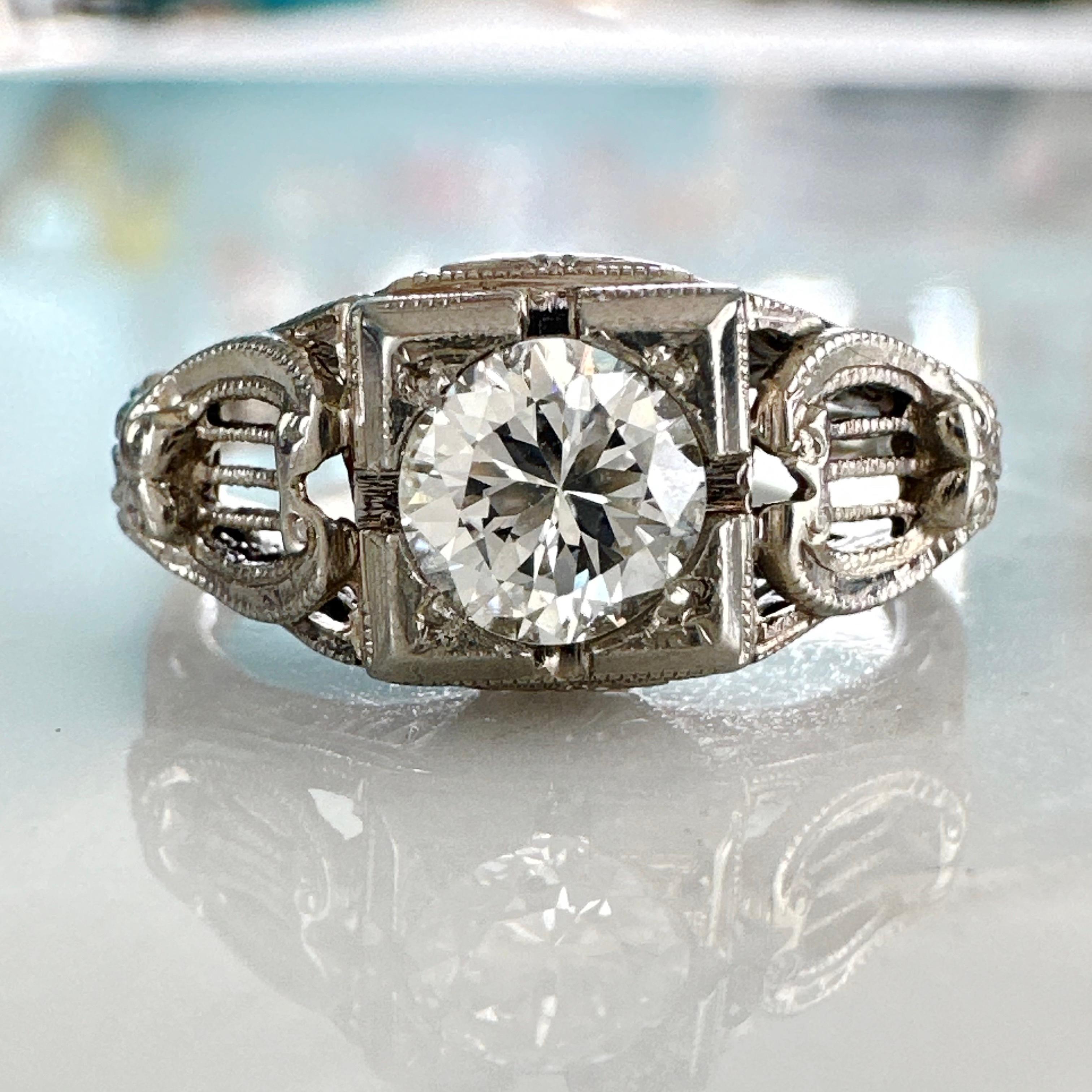 Details:
Art Deco Period 18K white gold filigree and diamond ring—would make a lovely wedding ring! Details in the filigree and engraved sides are very musical, with filigree cut outs resembling a harp, and tiny fleur de lis and flower details. Such