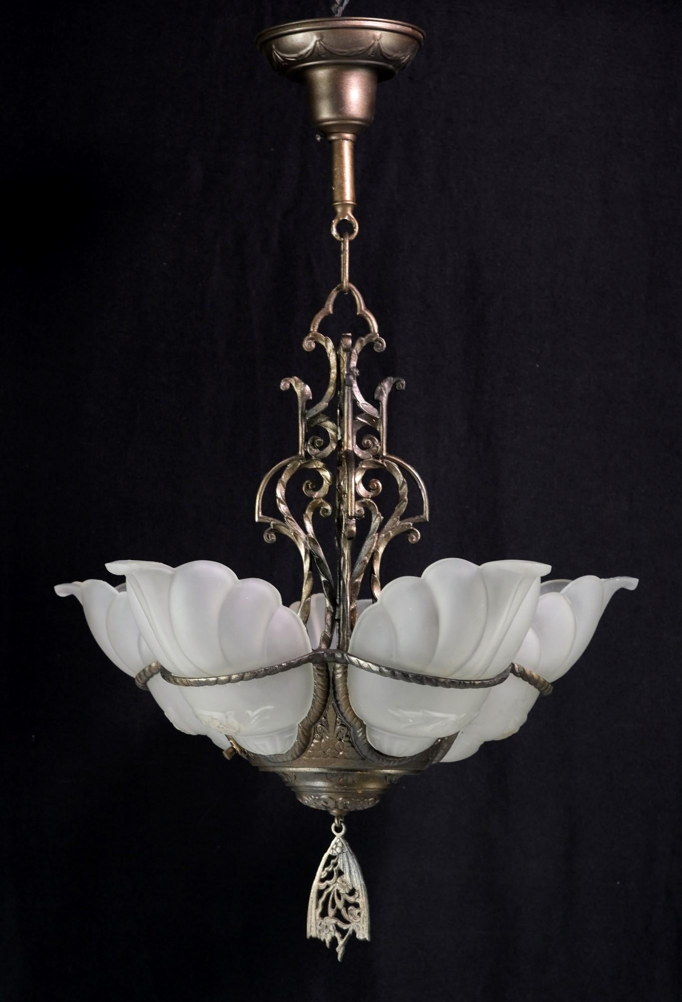 Antique 5 light bronze chandelier with slip shades in the Devon series style. This Art Deco Chandelier has floral details, with the shades consisting of frosted white glass in a floral design. The price includes restoration. This can be seen at our
