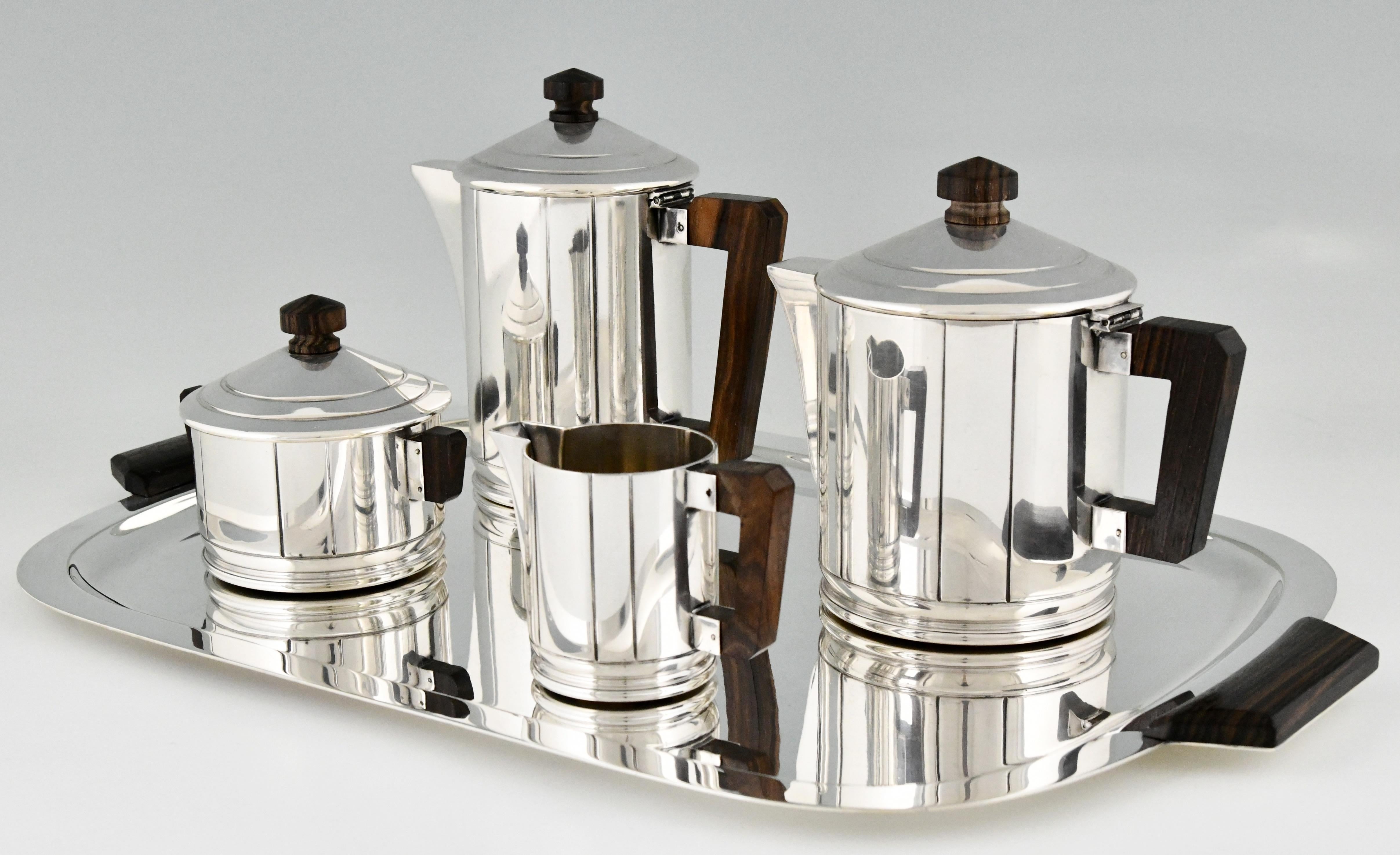 Beautiful designed Art Deco silvered coffee and tea set by Ercuis with Macassar wooden handles, France. Ca. 1930. 
Coffee pot, tea pot, sugar bowl, milk jug, tray. 
Literature:
