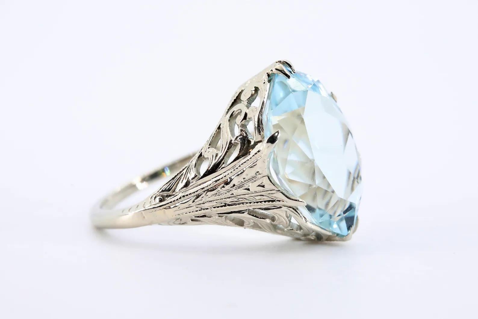An Art Deco period aquamarine solitaire ring crafted in 20 karat white gold. Centered by a fancy cut aquamarine of 5.00 carats displaying vivid sky blue color, and VVS clarity. 

Embracing the aquamarine, the 20 karat white gold mounting boasts hand