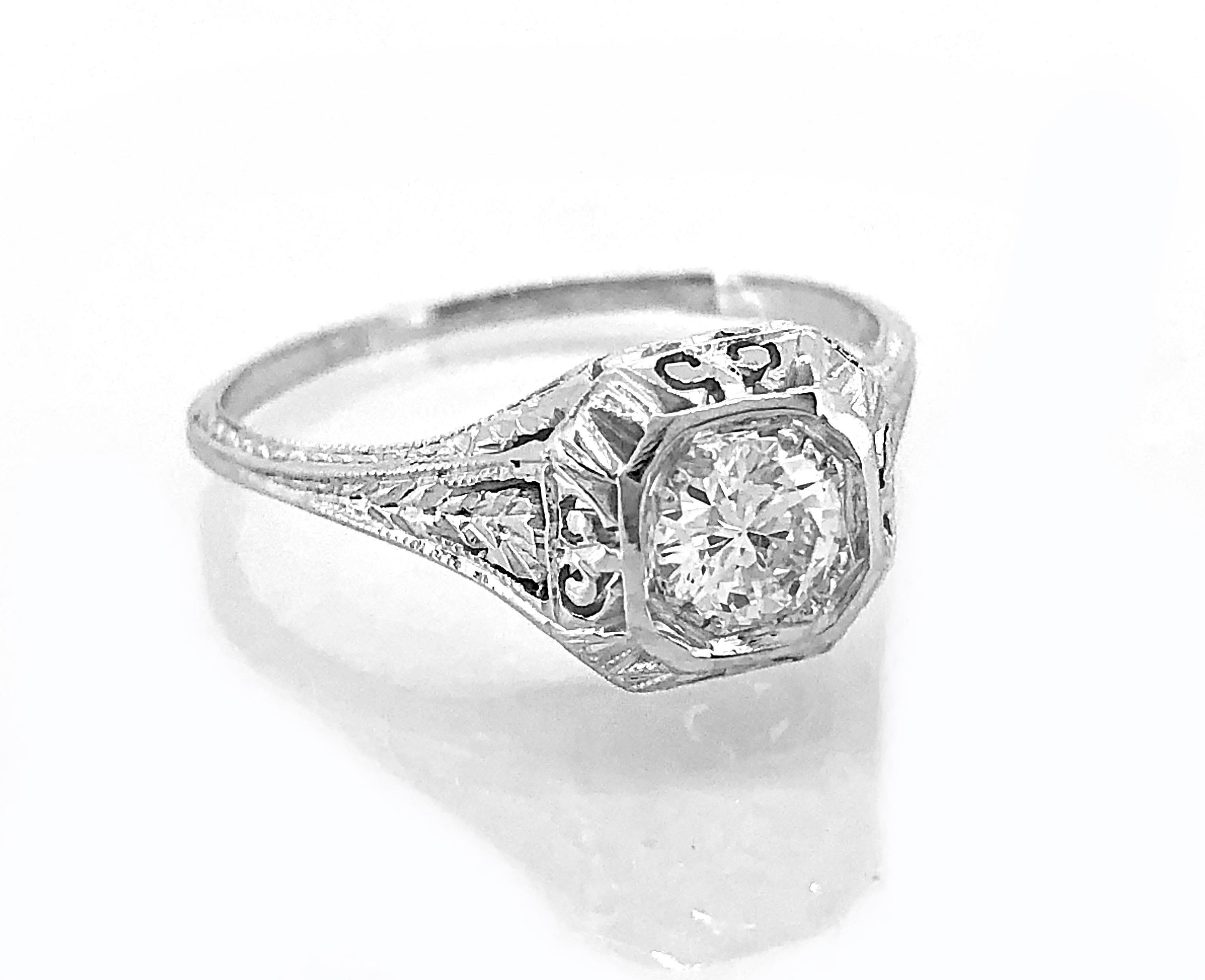 A highly filigreed antique engagement ring featuring a .53ct. apx. transitional cut center diamond. While this ring comes with an EGL cert stating it is an E-F color and VS2 clarity, we feel it is actually F-G color and SI1 clarity. This engagement
