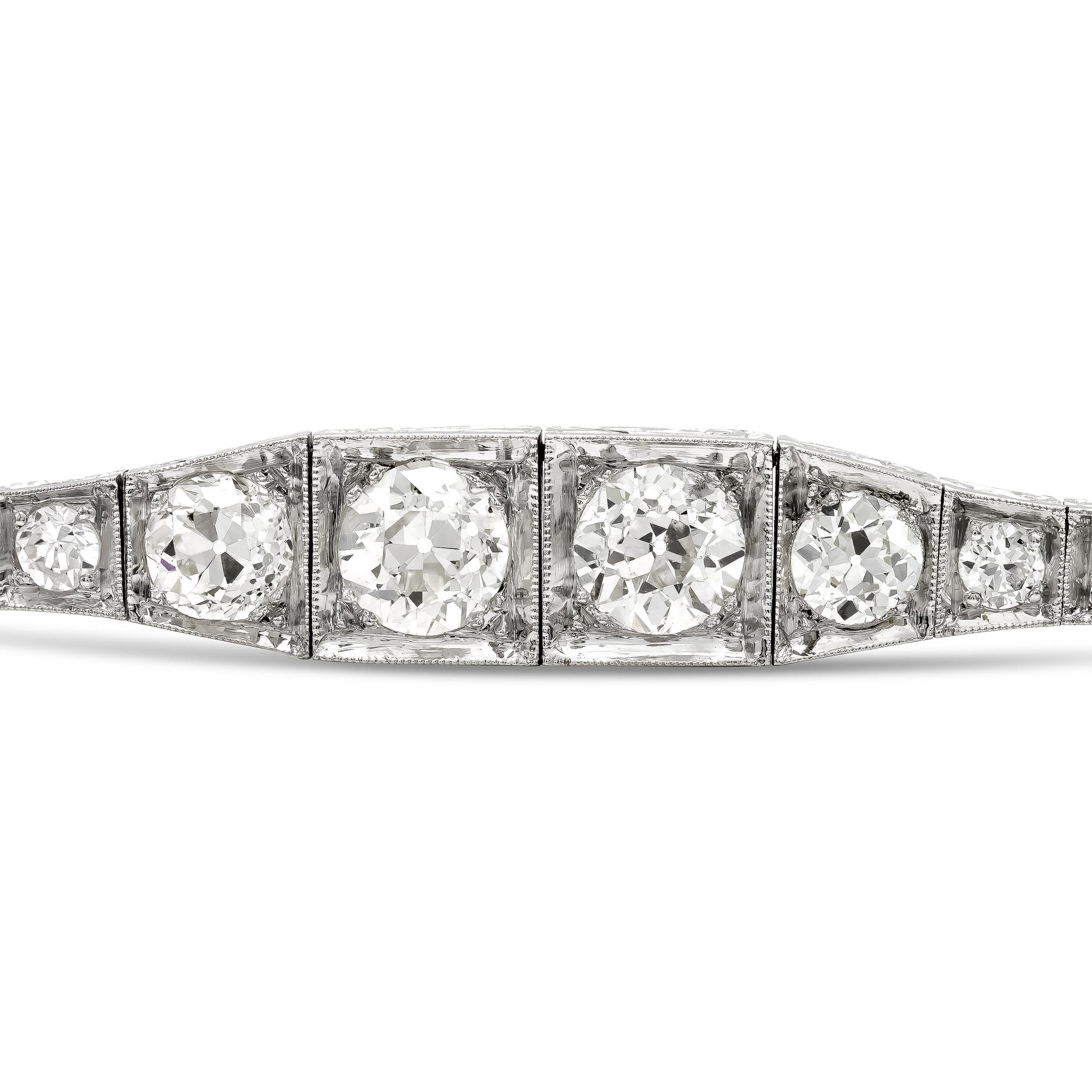 Arm yourself in style with this sophisticated and timeless Art Deco diamond line bracelet. She shimmers from end-to-end with 38 icy-white old European diamonds, that graduate to two 1.01 ct. diamonds at the center. Meticulously finished in platinum