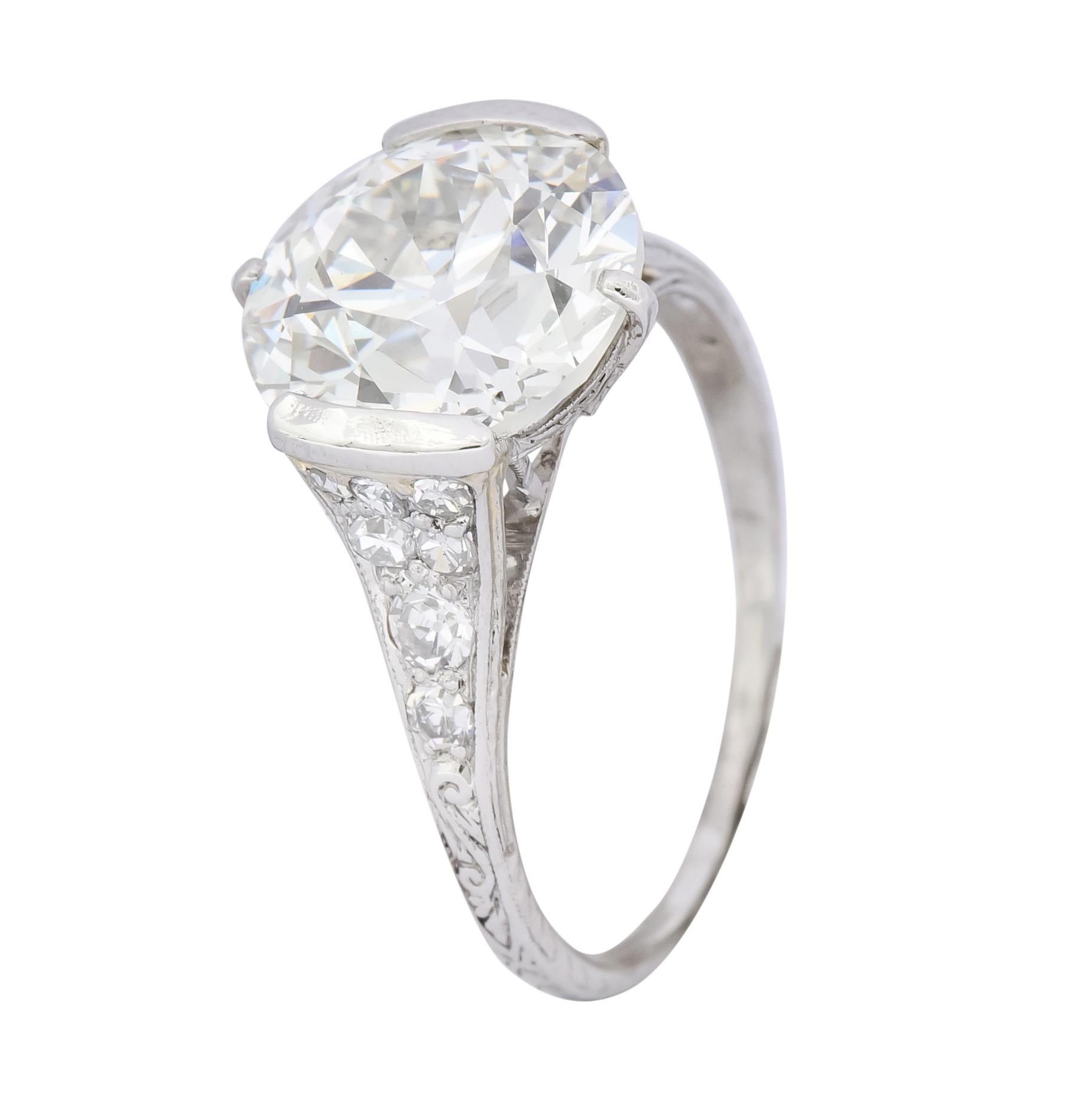Centering a half bezel set old European cut diamond weighing 4.82 carats total, J color and VS2 clarity

Flanked by single cut diamonds, pavé set in shoulders, weighing approximately 0.55 carat, H to J color and VS clarity

Cathedral basket style