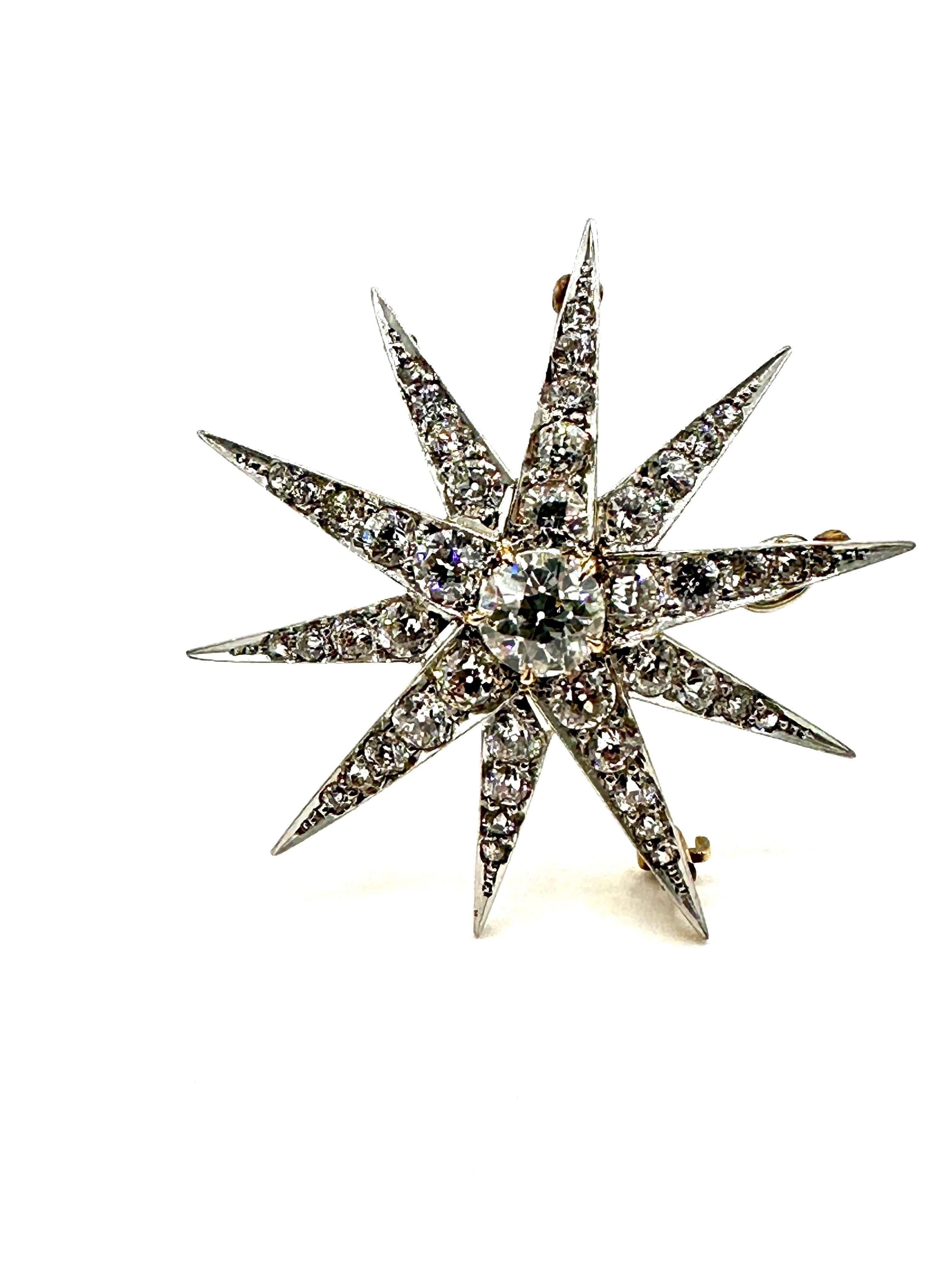 This is an incredibly vibrant old European cut Diamond pendant brooch.  The piece is et with a single 1.20 carat old European cut Diamond center, graded as J color, VS clarity.  This is surrounded by 10 starbursts extending outward, containing 4.40