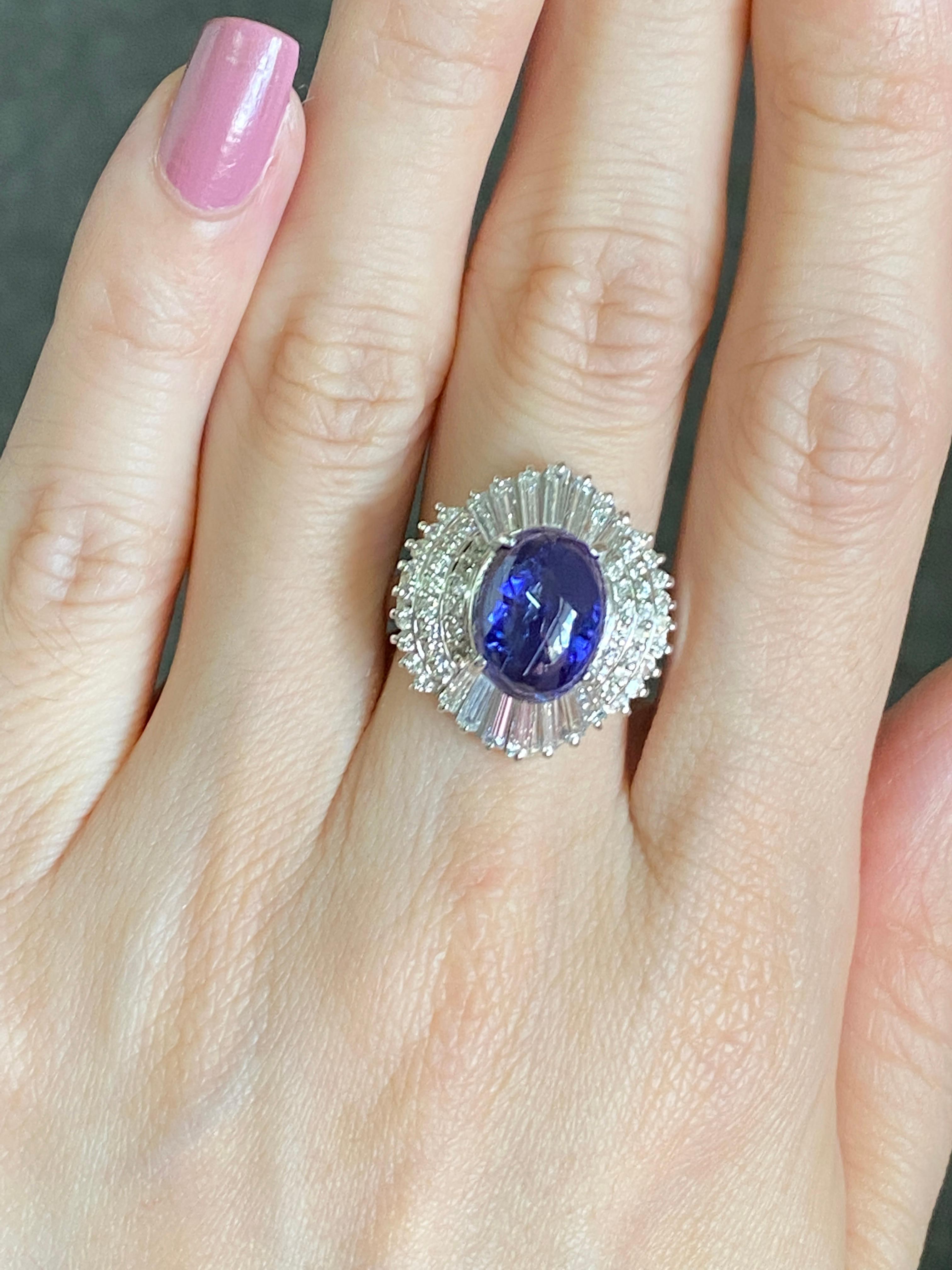 A 5.63 carat Tanzanite Cabochon set in a classic, art-deco looking setting with  1.69 carat Diamond Baguettes and Rounds. The ring is made using 10.45 grams of Platinum. The centre stone is a natural tanzanite, which is absolutely transparent and