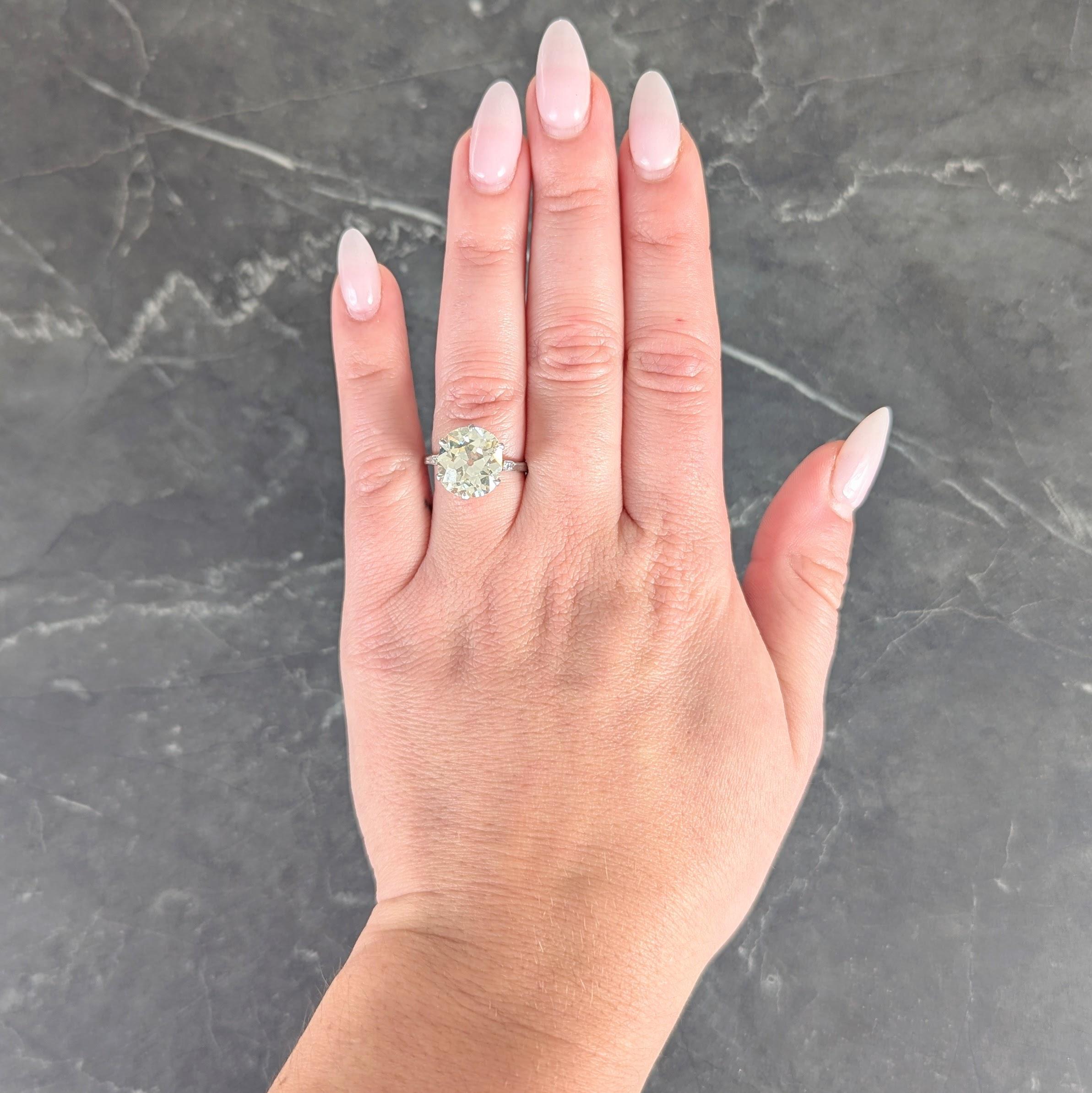 Centering an old mine cut diamond weighing 5.71 carats - S to T color with I1 clarity
Set with talon prongs in a pierced arching basket flanked by cathedral shoulders
Pierced with arch motif and bead set with single cut diamonds
Weighing
