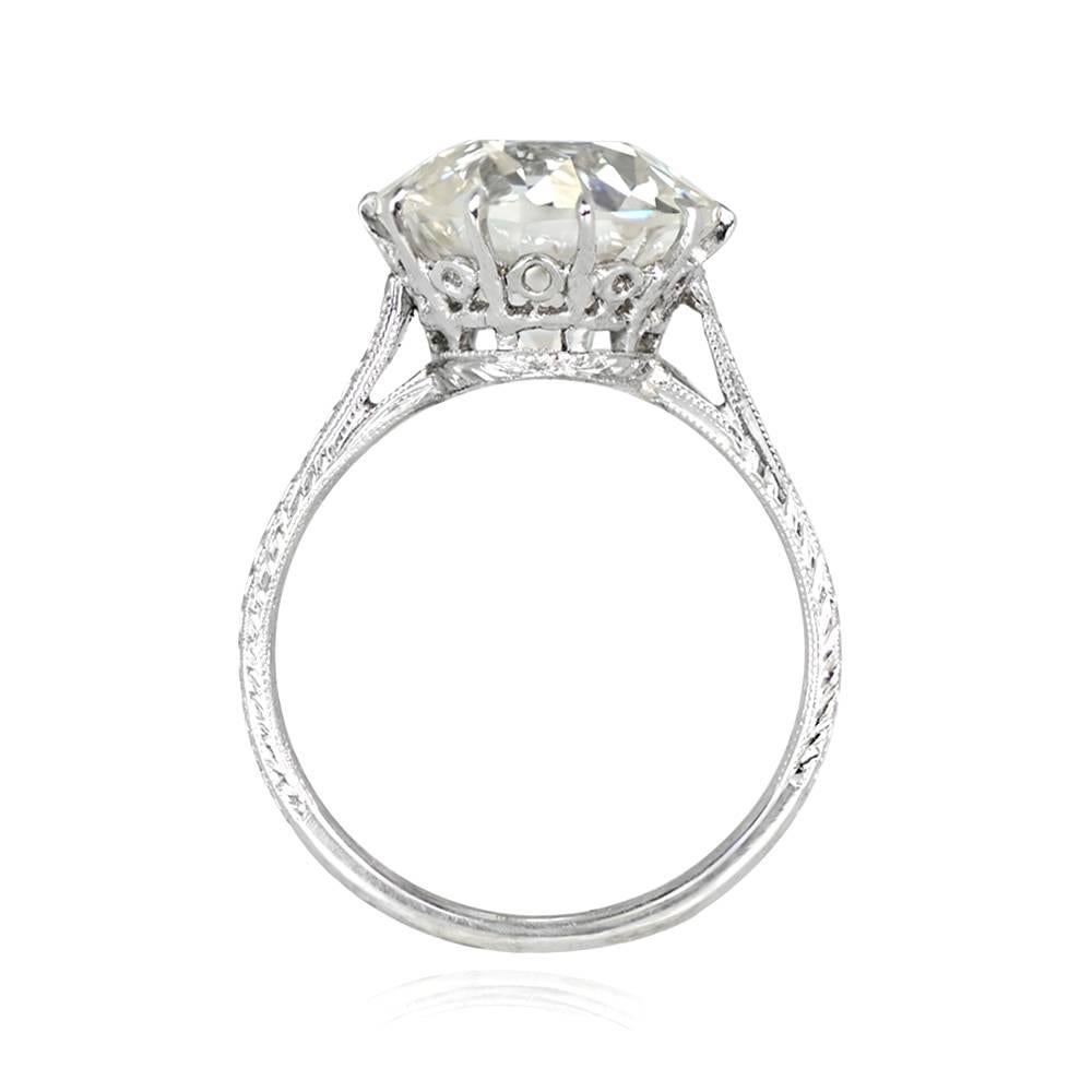 This is a stunning art Deco engagement ring with a 5.81 carat old European cut diamond (J color, VS1 clarity), featuring a crown-style under-gallery and intricate hand-engravings on the shoulders, shank, and under-gallery. Handcrafted in platinum