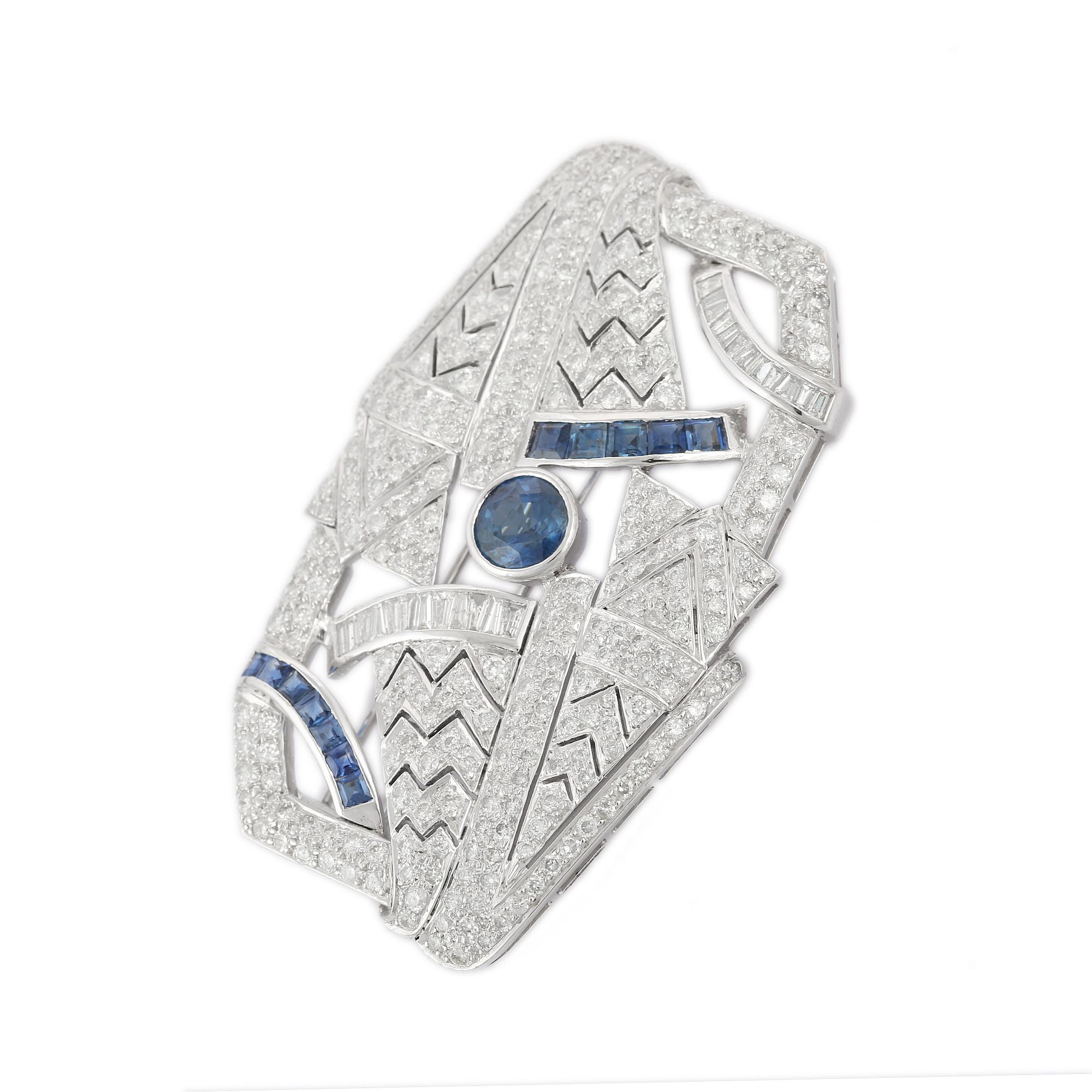  Art Deco 5.96 CTW Diamond 3.9 CTW Sapphire Brooch in 18K Gold which is a fusion of surrealism and pop-art, designed to make a bold statement. Crafted with love and attention to detail, this features 3.9 carats of sapphires and 5.96 carats of