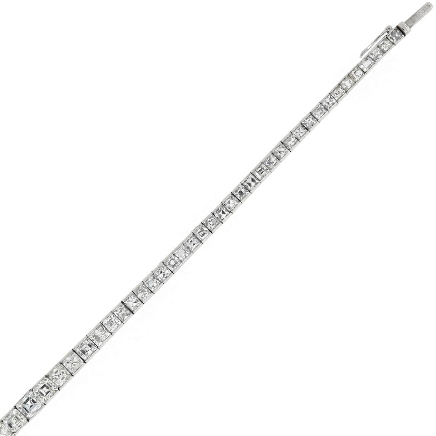 An absolutely exquisite and unusual diamond line bracelet from the Art Deco (ca1920) era! Crafted in platinum, this gorgeous piece is comprised of 71 varying yet complimentary square Step Cut diamond links which graduate slightly towards the center.