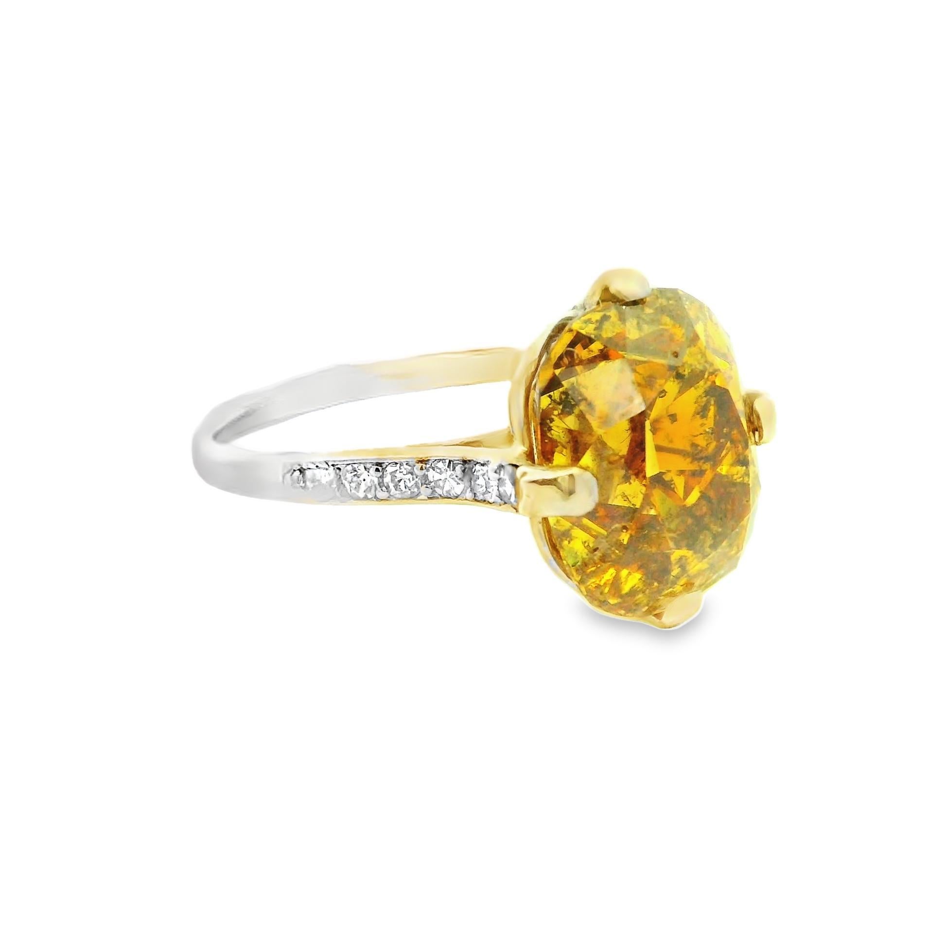 An original Art Deco piece made in the 1920’s, this lovely ring features a beautiful richly colored natural fancy colored diamond. The diamond weighs 6.24 carats and has a super-rich deep brownish-orangy-yellow gold that absolutely glows in the