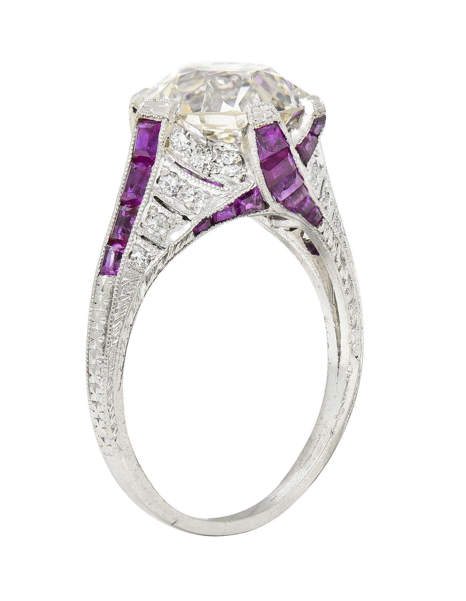 Centering an old European cut diamond weighing 3.75 carats - M color with VS2 clarity
Set with wide prongs and flanked by rows of calibré cut ruby shoulders and 'X' motif profile
Weighing approximately 2.20 carats total - transparent purplish red in