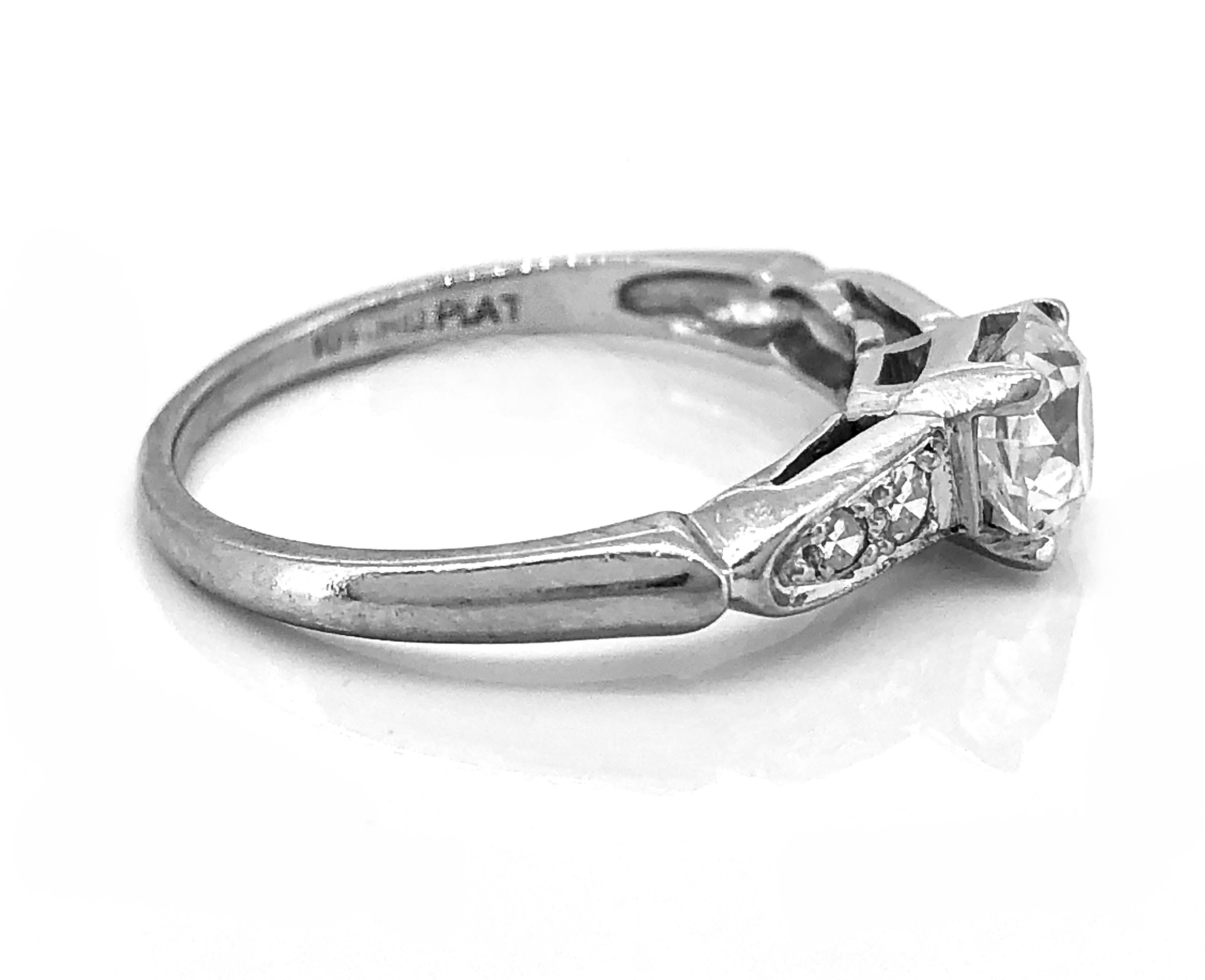 A gorgeous Art Deco Platinum & Diamond Antique Engagement Ring. It features a scintillating .70ct. apx. VS2 clarity and H color European cut diamond. The center diamond is accented with .08ct. T.W. apx. single cut diamond melee. This ring is