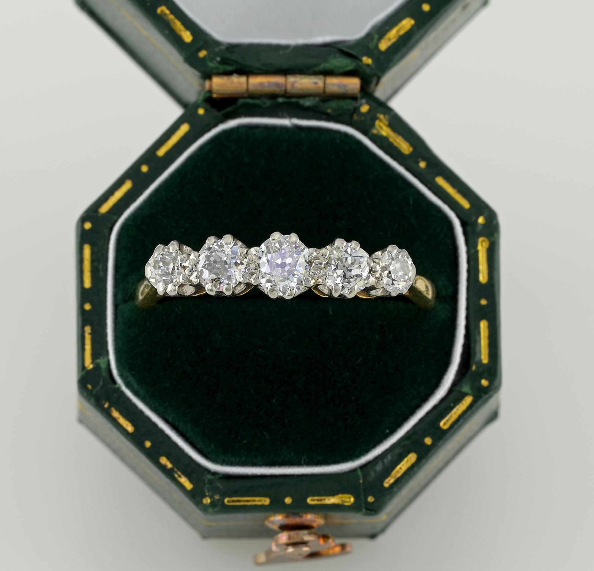 This pretty antique five stone ring is 1920 ca.
Hand crafted of solid 18 KT gold and Platinum
Traditional five stone setting with uplifted array slightly graduated in size of old mine cut Diamonds for .70 Ct –  larger is .20 Ct. superb in quality