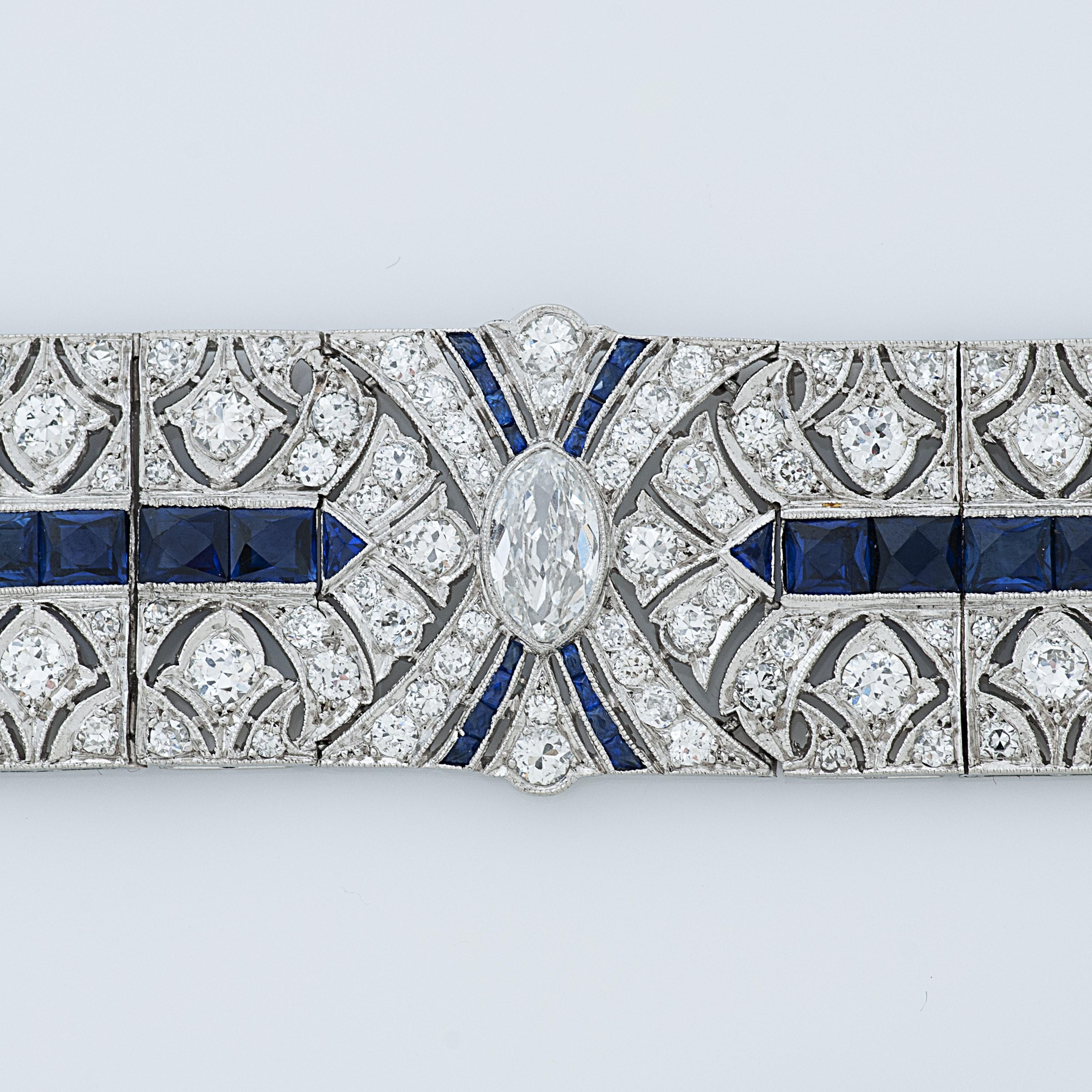 Art Deco diamond and sapphire platinum bracelet.

The center stone of this bracelet is a 0.65 carat marquise shaped diamond with G color and SI clarity, it is surrounded by 40 old mine cut and old European cut diamonds totaling approximately 3.80