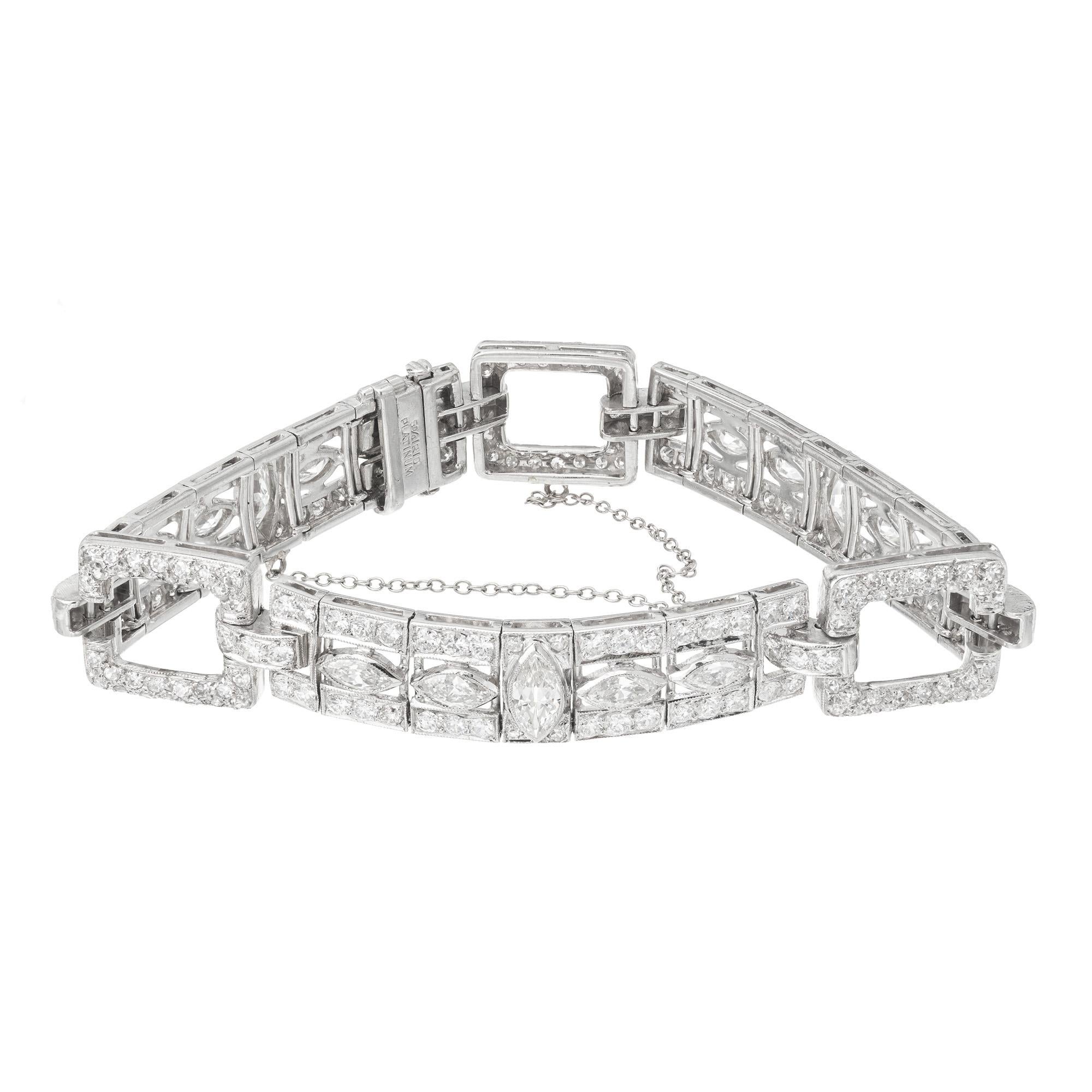 Spectacular Art Deco 1930's diamond link bracelet. This vintage bracelet is adorned with 15 marquise bezel set diamonds and accented by 216 round cut diamonds. This highly detailed bracelet is made of 95% platinum and 5% Iridium.  The links are box