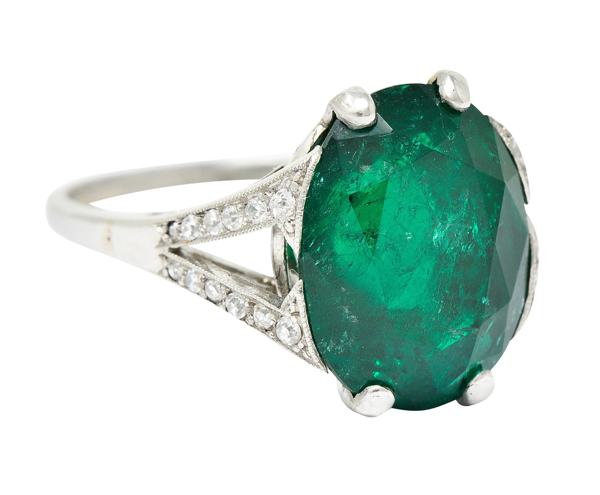 Basket cathedral style statement ring with elegantly scrolled gallery

Centering an oval cut Colombian emerald weighing approximately 7.10 carats
Bright saturated green in color and semi-transparent with natural inclusions - moderate clarity