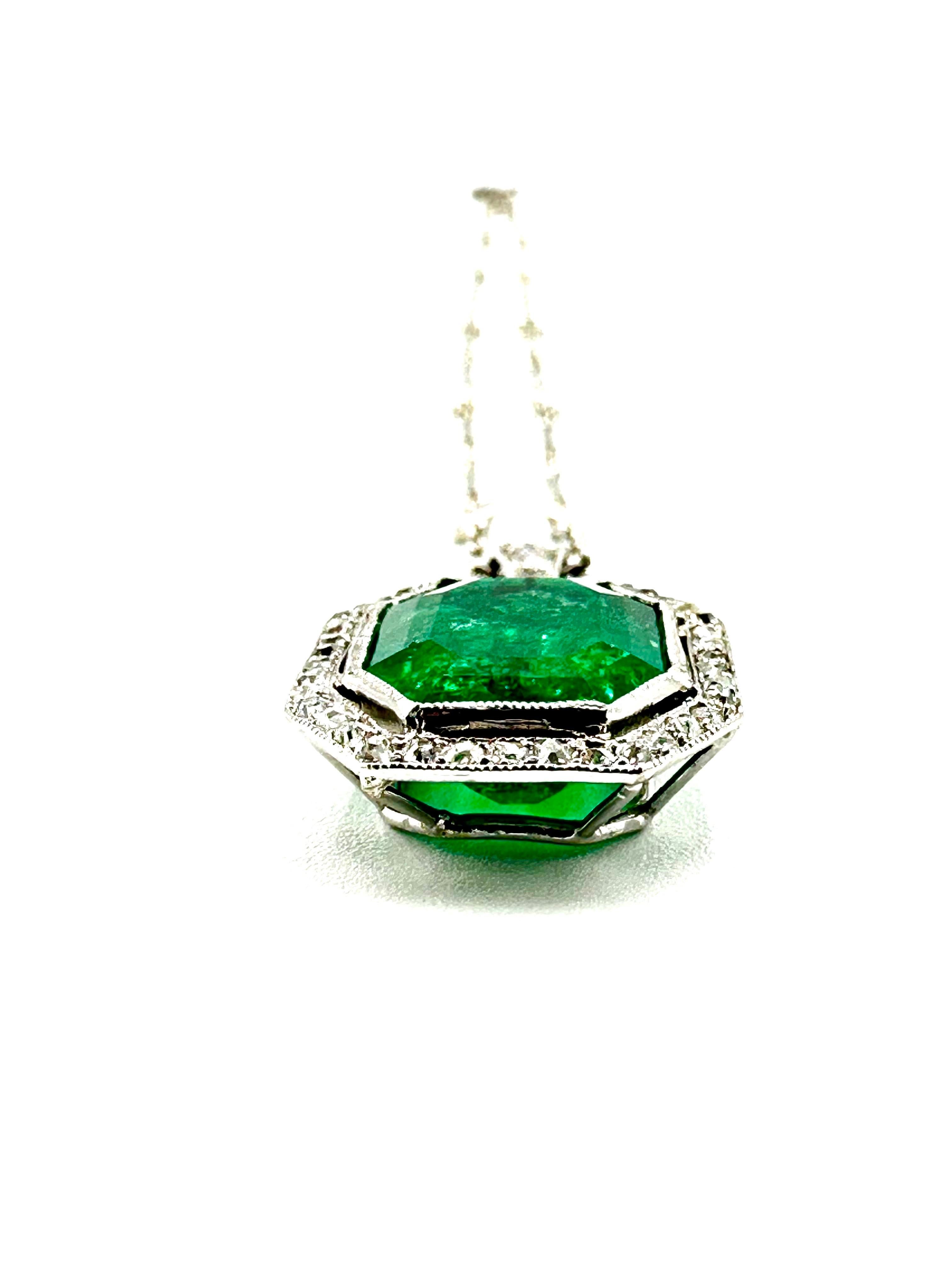 A stunning Art Deco natural Colombian Emerald pendant necklace!  The Emerald is octagonal in shape, bezel set in platinum and surrounded by a single row of old mine cut Diamonds, suspended from a single larger round brilliant Diamond and Diamond