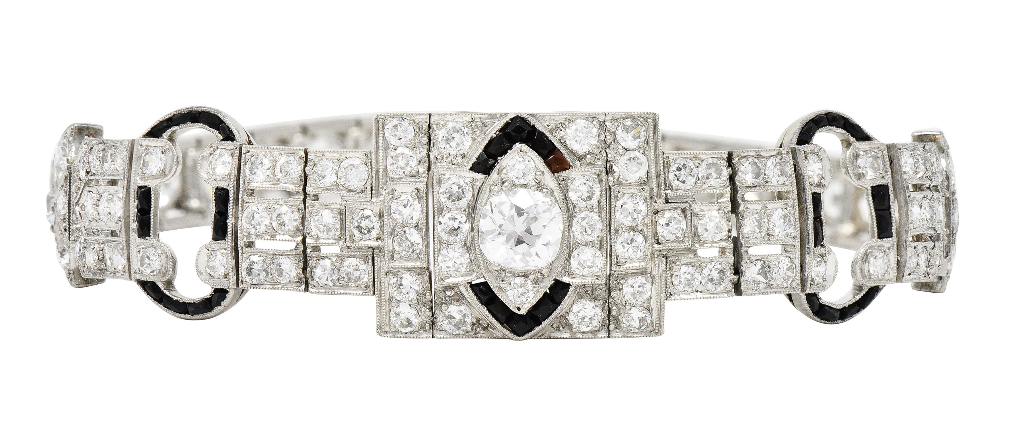 Comprised of hinged box links with pierced geometric stations centering an old mine cut diamond
Weighing approximately 0.76 carat - G color with VS2 clarity - bead set in marquise shaped surround
Featuring a halo surround and buckle motif stations