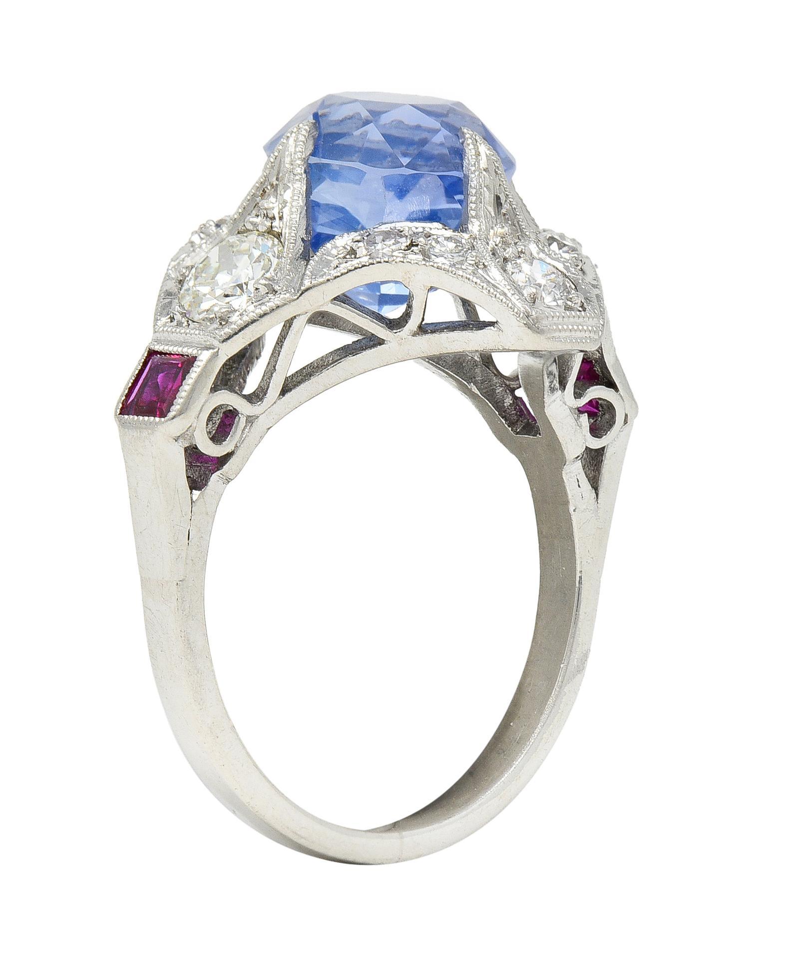 Centering a cushion cut sapphire weighing approximately 3.55 carats - transparent light cornflower blue in color
Natural Sri Lankan in origin with no indications of heat treatment - prong set to appear floating 
With talon prongs and