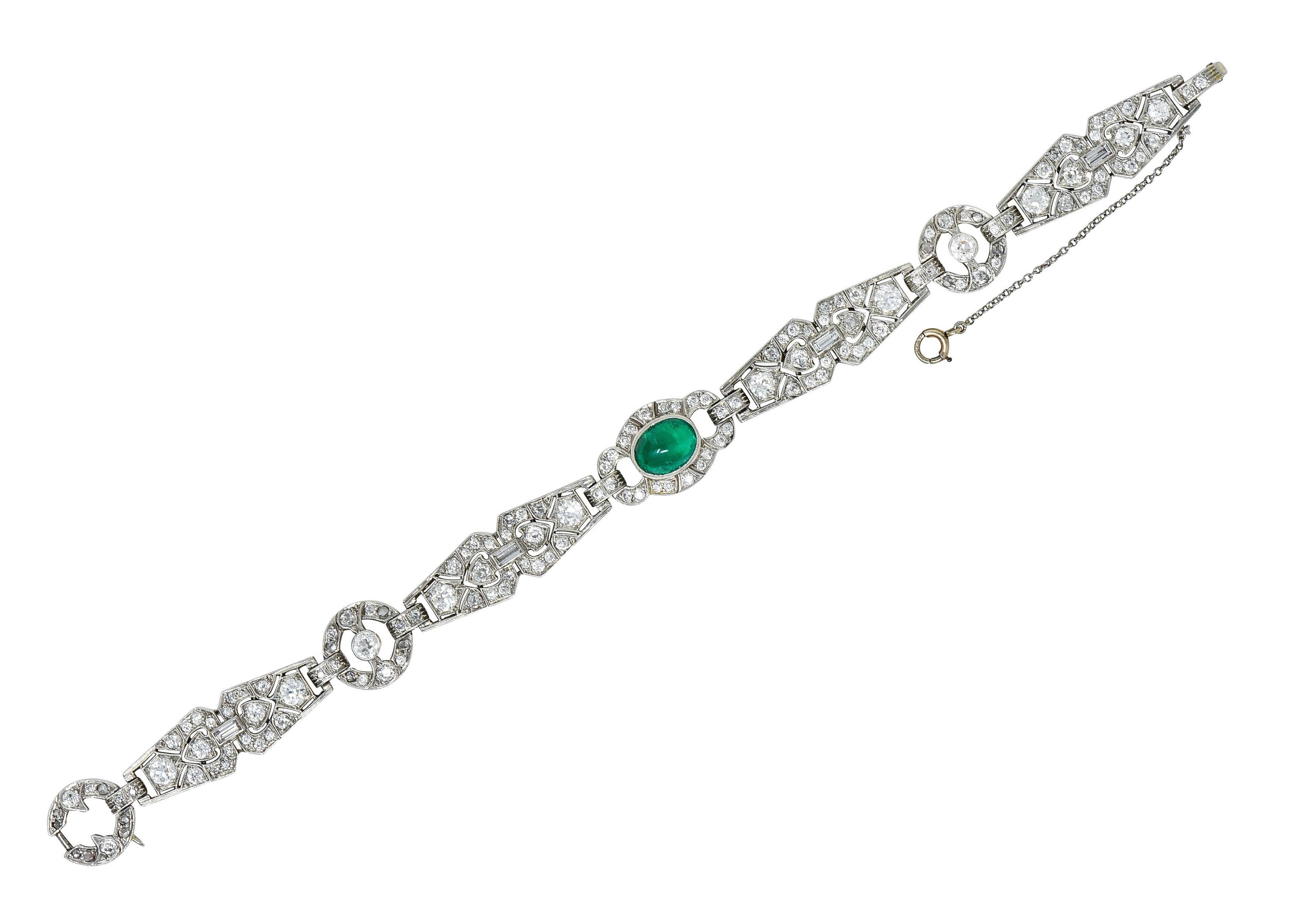 Bracelet is comprised of geometric links with fanciful milgrain edges

Featuring an oval double cabochon of emerald weighing approximately 2.50 carats

Slightly bluish and strongly green in color while exhibiting semi-transparency due to natural