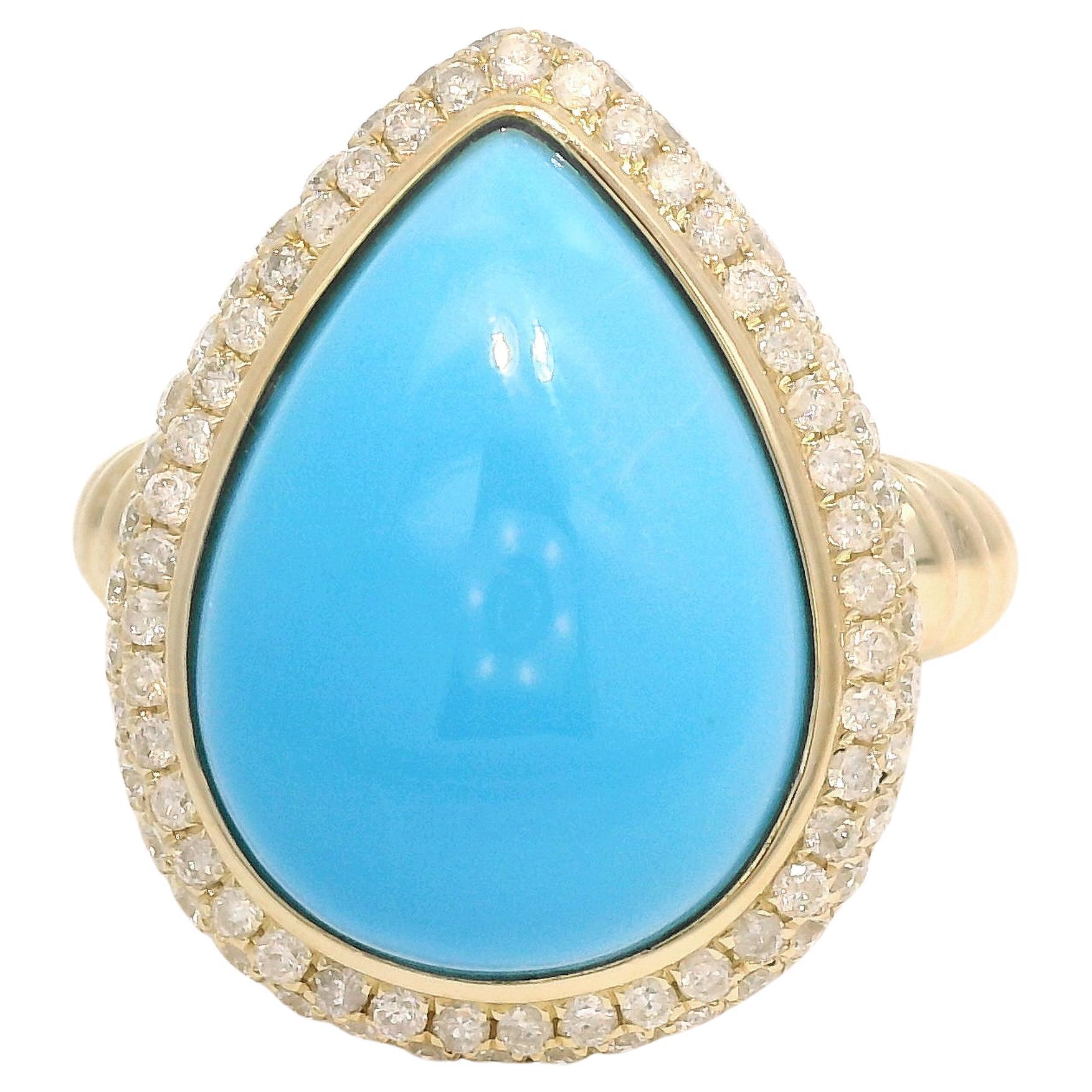 This captivating 14K yellow gold ring is a true showstopper, featuring a stunning pear-shaped sleeping beauty turquoise centerpiece weighing 8.1 carats. The vibrant blue hue of the turquoise is elegantly framed by a halo of 0.73 carats of sparkling