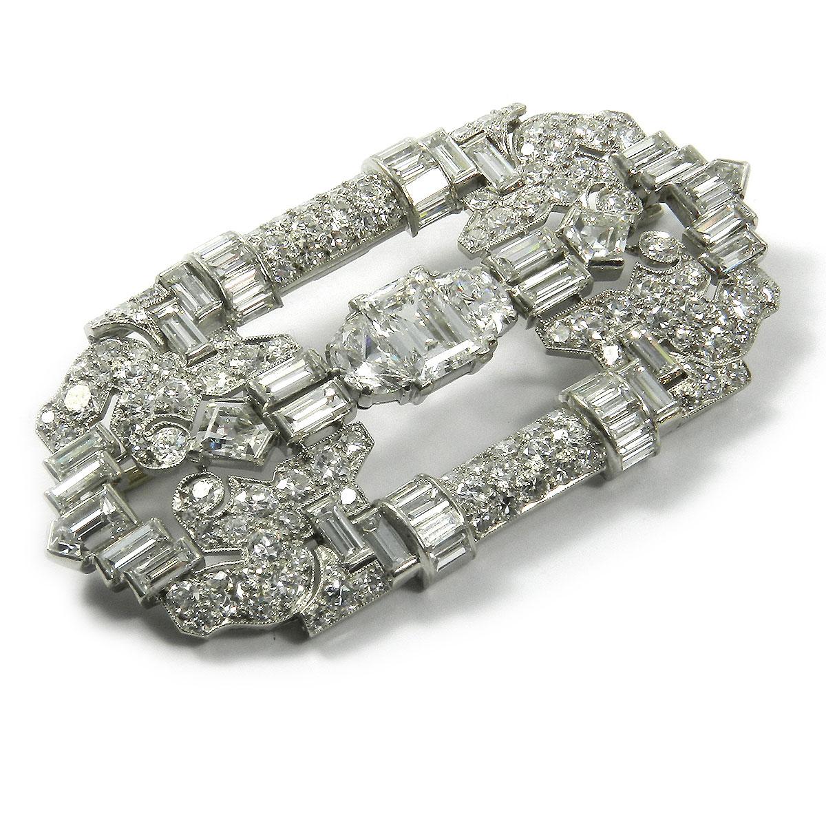 Art Deco 8.43 carat diamond and platinum Brooch circa 1920

This decorative brooch is geometrically designed with a central baguette diamond of 1.19 carat, surrounded by 162 diamonds in baguette, crescent and transition cut with a total of 7.24