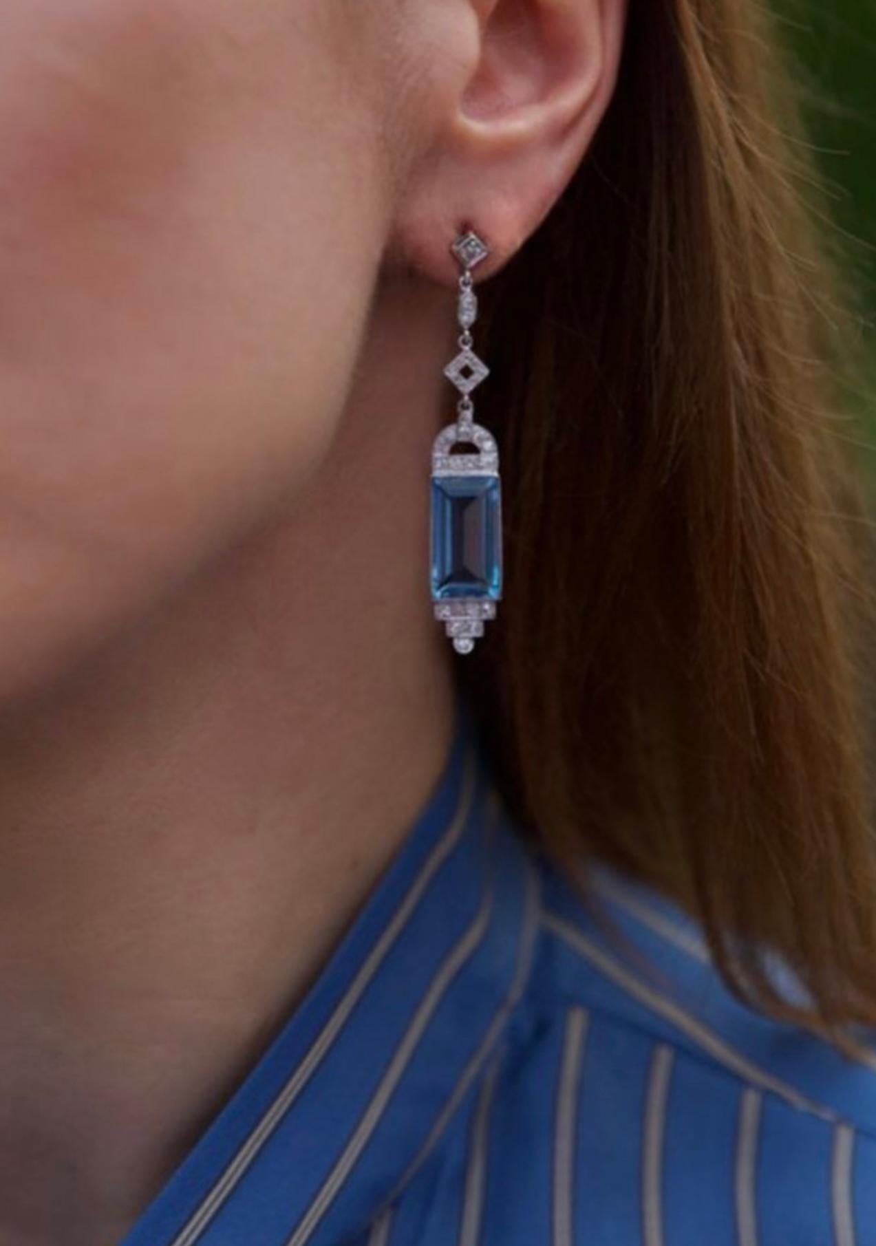 Art Deco 18kt white gold pair dangle earrings with octagonal, rectangular step cut natural Aquamarine and forty six single cut natural diamonds. 
Made in Europe, Ca. 1930's

Comes with WGI certificate. 

Dimensions -
Length x width x depth: 5.5 x 1