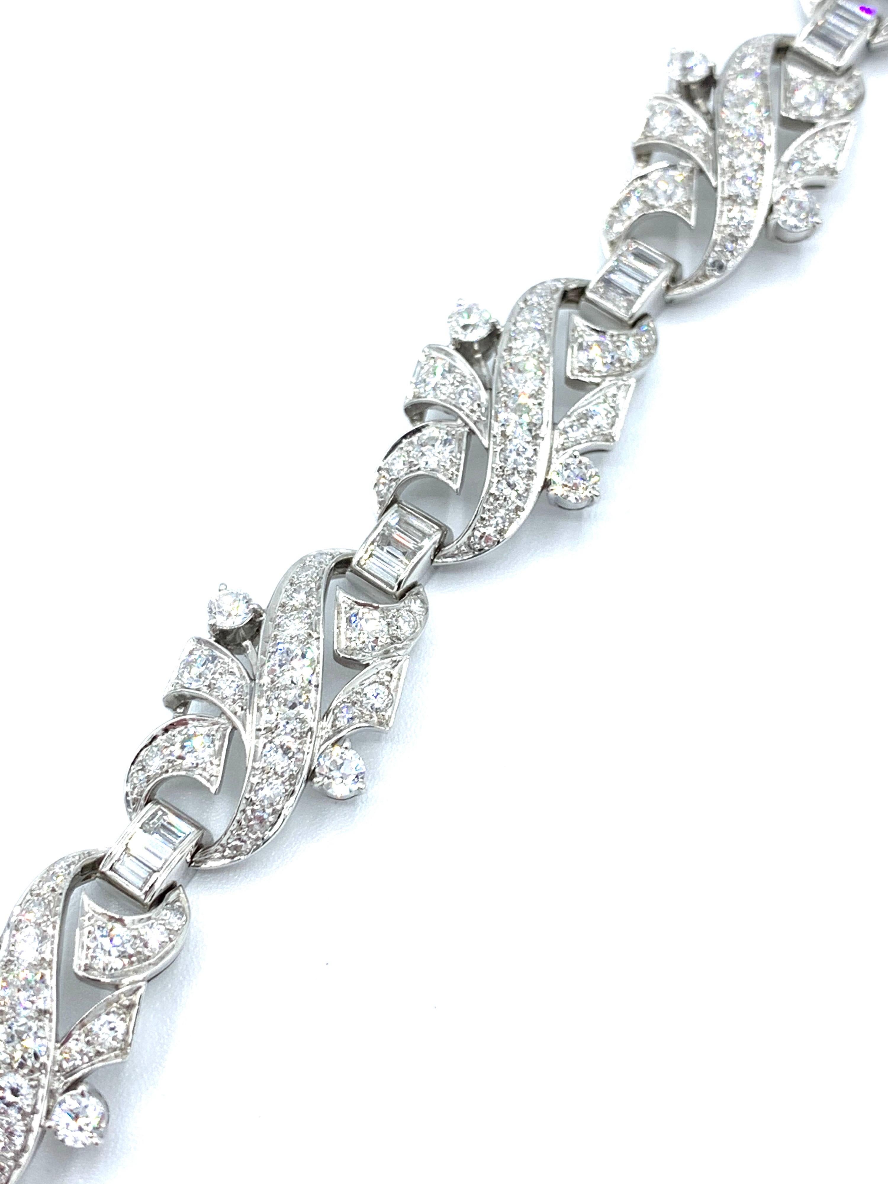 A stunning Art Deco Style Diamond and platinum bracelet.  The mix of round cuts and baguette Diamonds make this bracelet gleam with light!  The Diamonds have a total weight of 8.68 carats, and are graded as G-H color, VS clarity.  The bracelet
