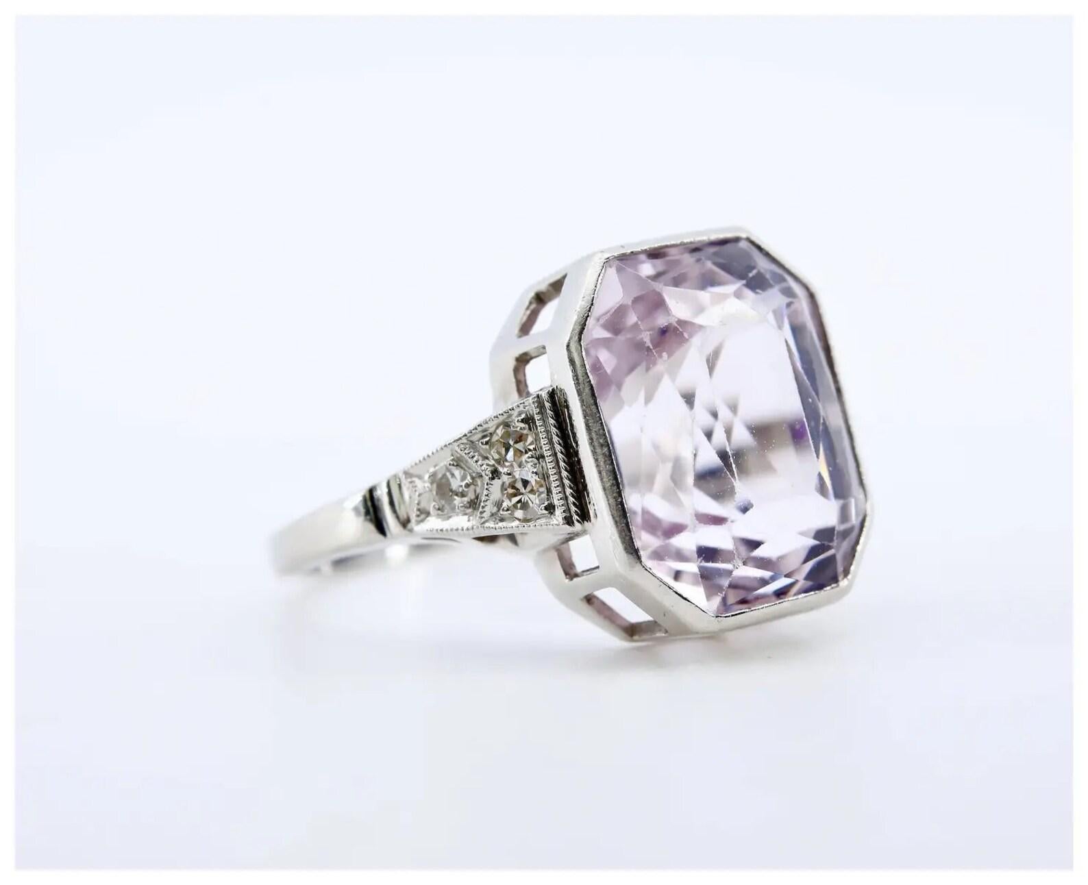 An Art Deco period kunzite, and pave set diamond cocktail ring in platinum.

Centered by an 8.75 carat bezel set pale pink kunzite.

Accented by six pave set diamonds of 0.12ctw with G color and VS2 clarity.

Hallmarked, and tested as