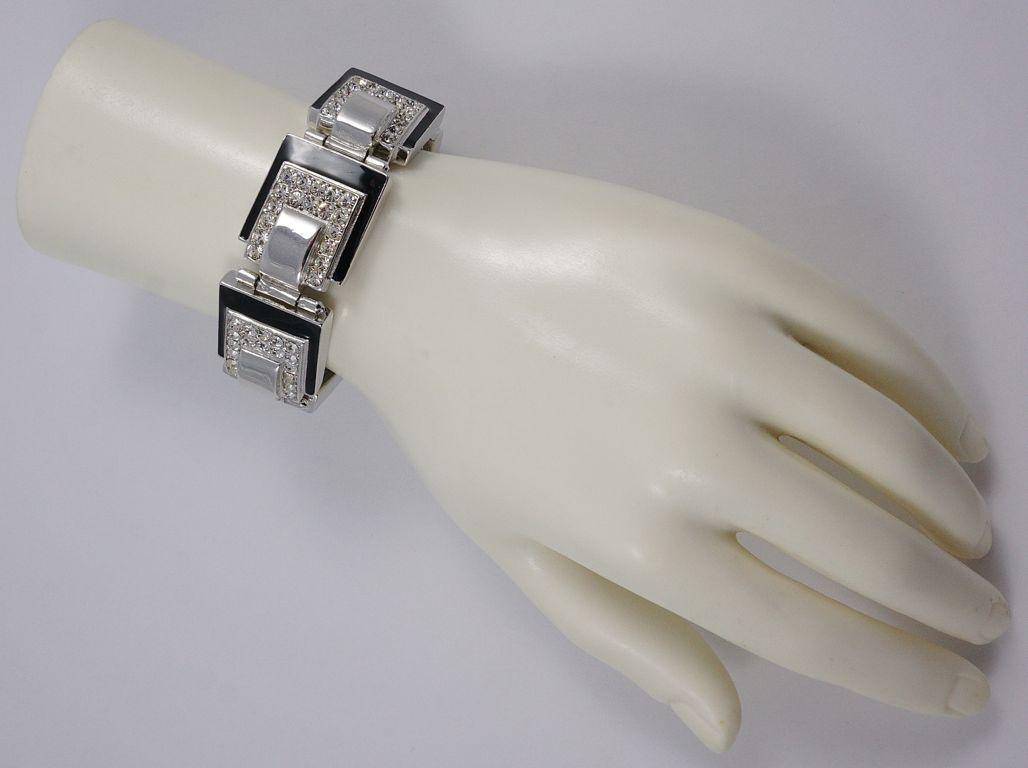 Art Deco 89 fabulous silver plated link bracelet, featuring seven square panels set with clear faceted rhinestones and black enamel, serial number B066. Measuring length 20.2cm / 7.95 inches by width 2.15cm / .84 inch, and maximum depth 8mm / .3