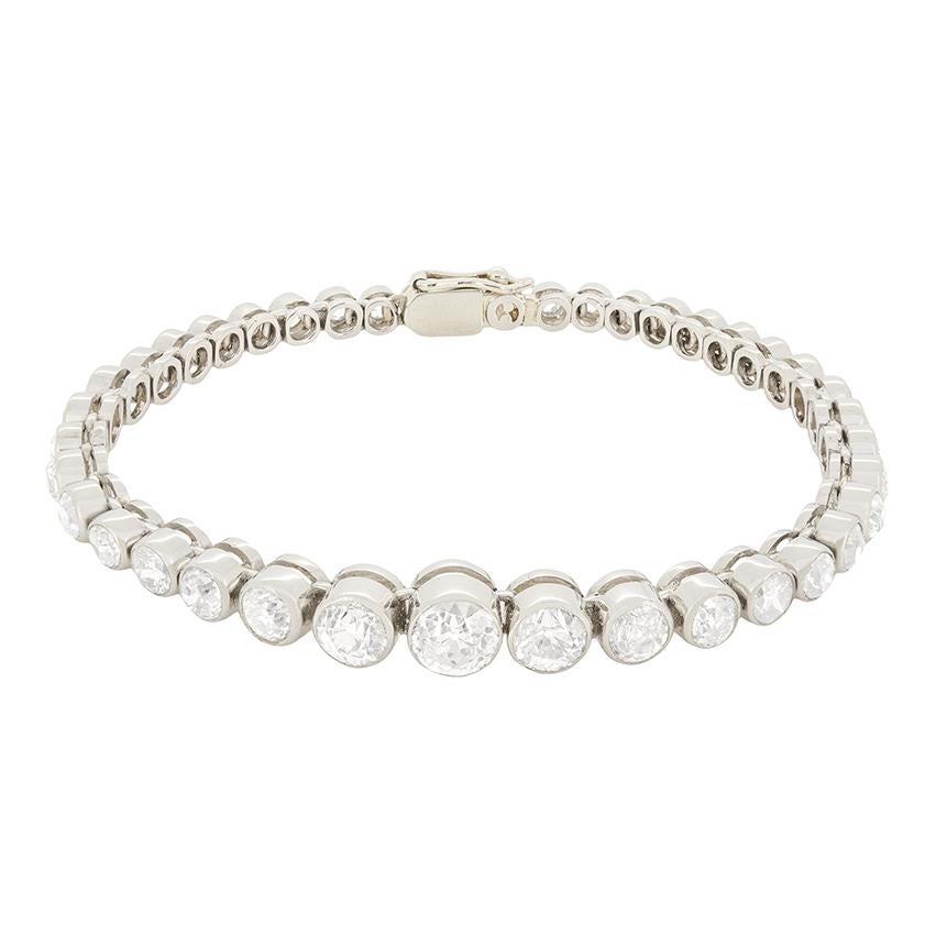 An exquisite Art Deco line bracelet set with graduating old cut diamonds starting with the smallest at either end weighing 0.05 carats, leading to the main centre stone weighing a substantial 0.90 carats. They combine to 8.90 carats and their