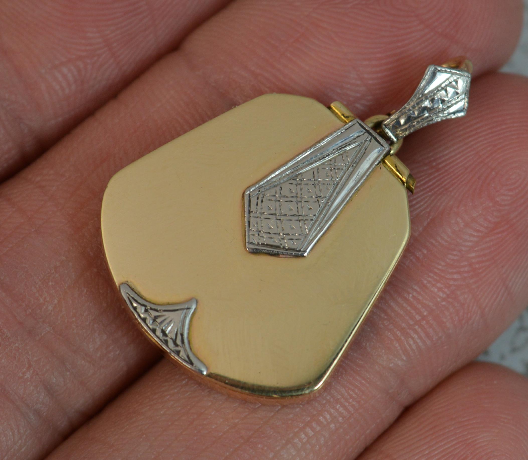 A gorgeous Art Deco period locket pendant.
True antique example, circa 1930.
Modelled in 9 carat yellow gold of plain design with patterned palladium pieces applied to front.
CONDITION ; Very good for age. Crisp design and hinge. Matching bale. No