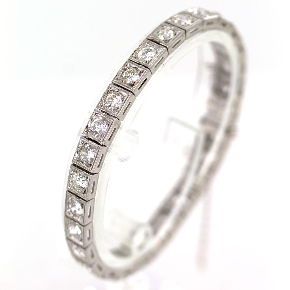 This timeless Art Deco diamond line bracelet is circa 1920's. The original platinum bracelet features 28 Old European Cut Diamonds (9.00 carat total weight) graded H-I color and VS2-SI2 clarity. The diamonds are set in square platinum links and